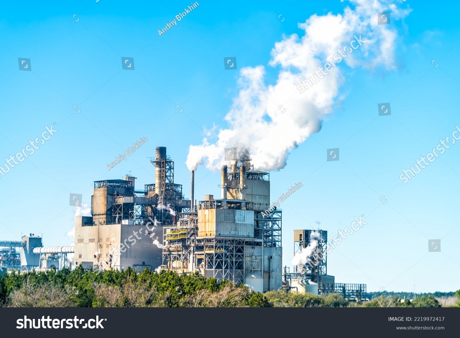 Industrial paper mill factory plant with chimney smokestacks stacks emitting carbon dioxide emission pollution in Georgetown, South Carolina town #2219972417