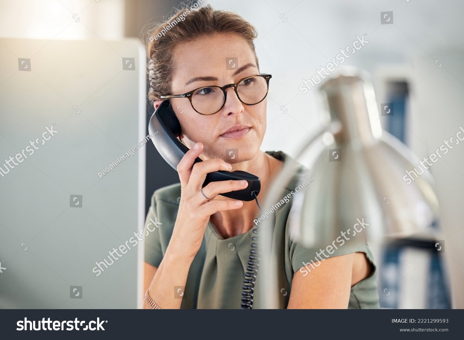 Telephone, phone call and business woman in office, talking and thinking. Landline, communication and female employee from Canada on call speaking, chatting or work discussion in company workplace. #2221299593