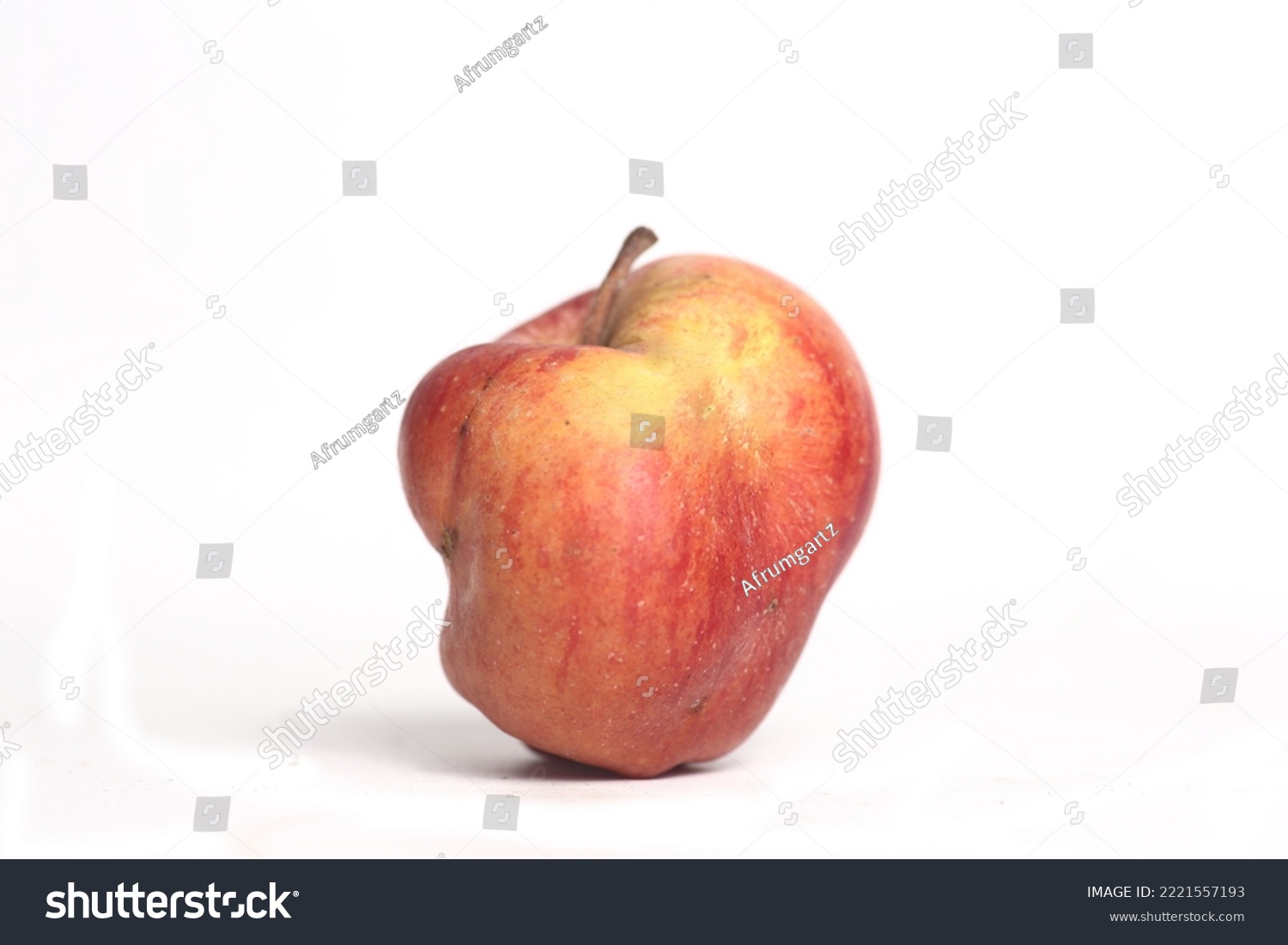 Concept of ugly food - red apple on white background. Image contains copy space #2221557193