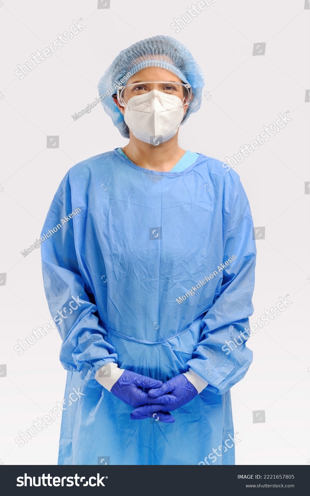 studio portrait of 40s hispanic female surgery doctor or researcher with full protective cloth of PPE gown face mask cap and surgery glove isolated on white background #2221657805