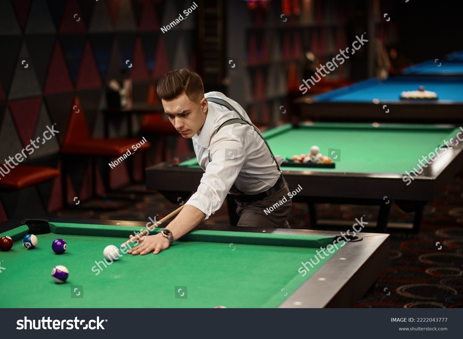 Portrait of man playing billiards #2222043777