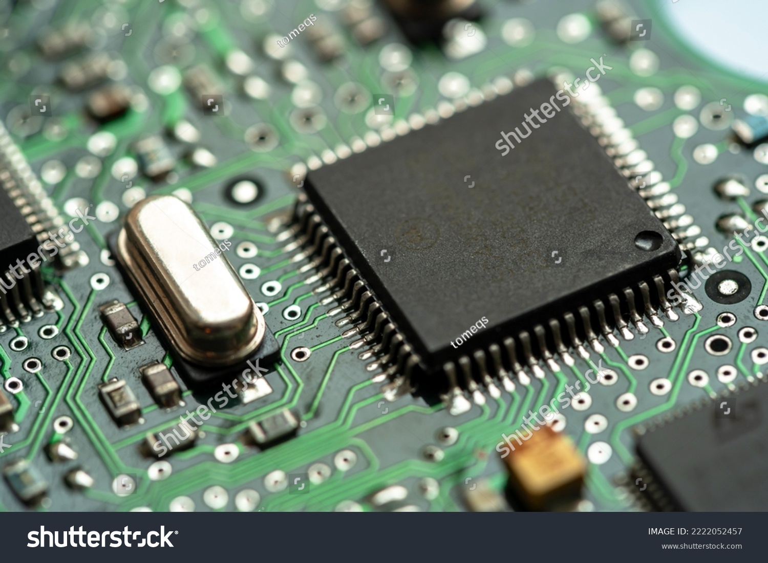 Small microprocessor, microcontroller chip on a generic modern desktop PC computer motherboard, object macro, extreme closeup, shallow dof, nobody Electrical components shortage concept, circuit board #2222052457