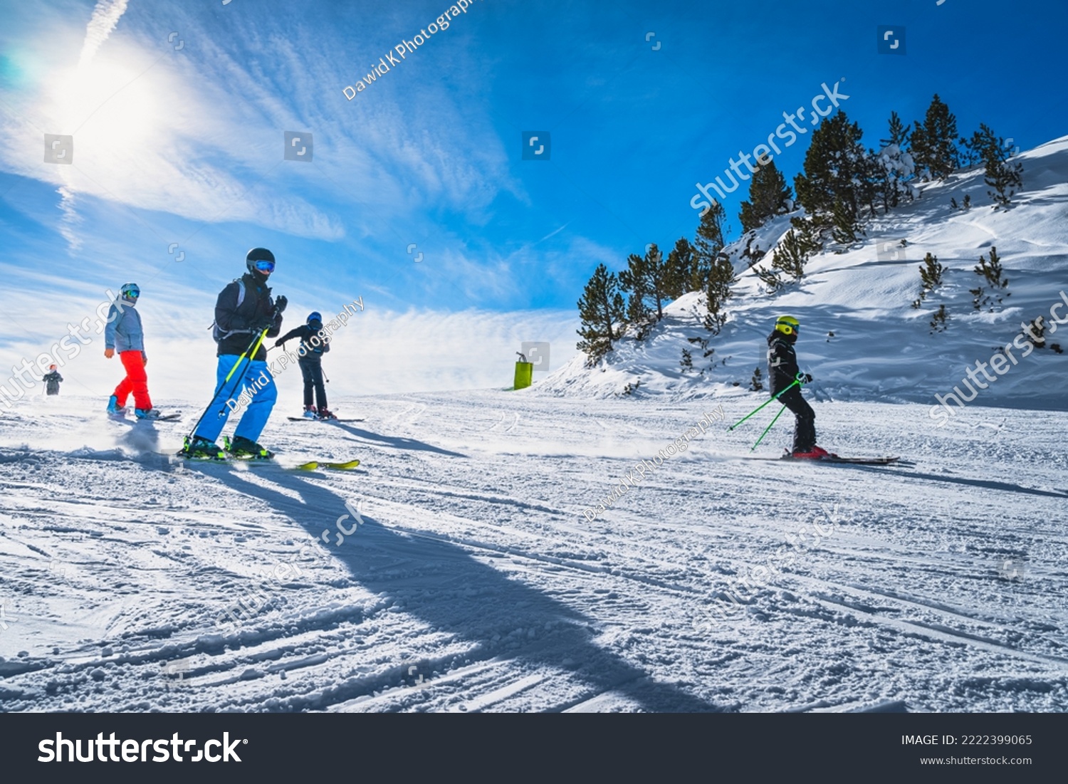 Group of people skiing and snowboarding down the ski slope or piste in Pyrenees Mountains. Winter ski holidays in El Tarter, Grandvalira, Andorra #2222399065