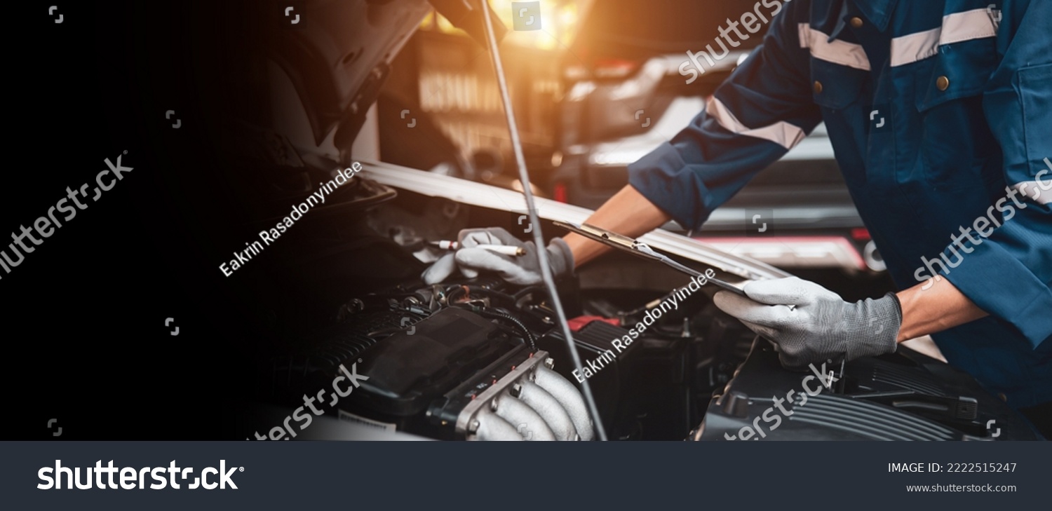 Car care maintenance and servicing, Close-up hand technician auto mechanic checking inspection list after repairing change spare part car engine problem and car insurance service. #2222515247