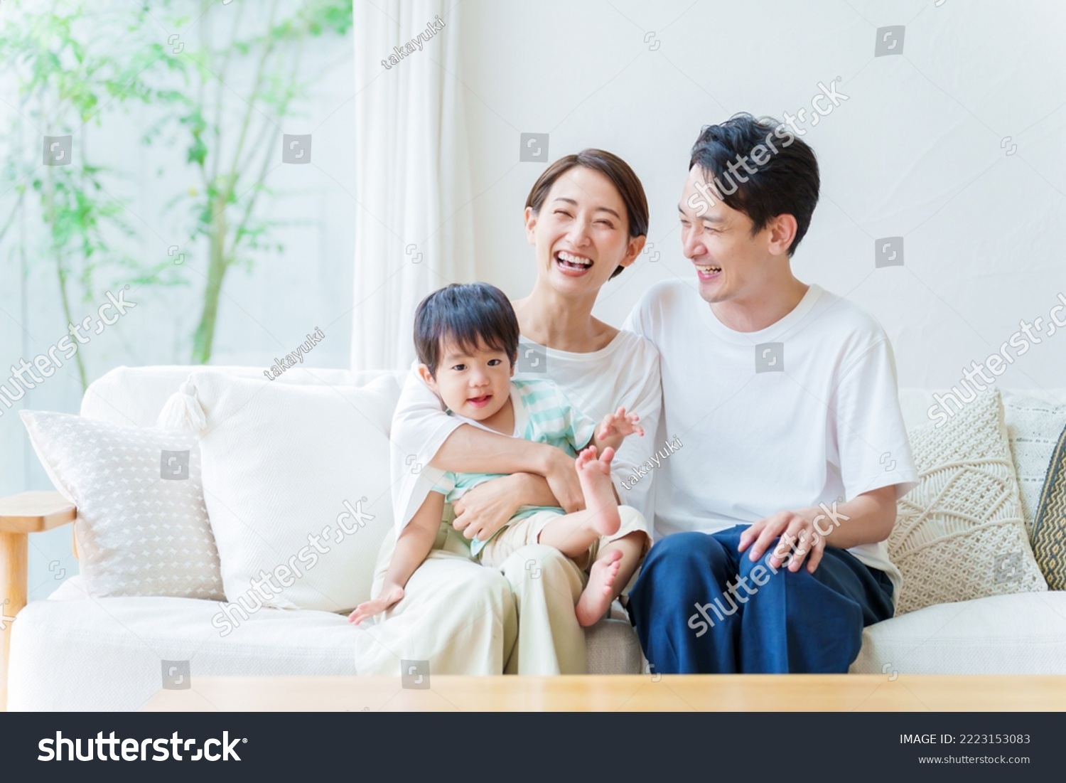 asian parents and boy relaxing in the living room #2223153083