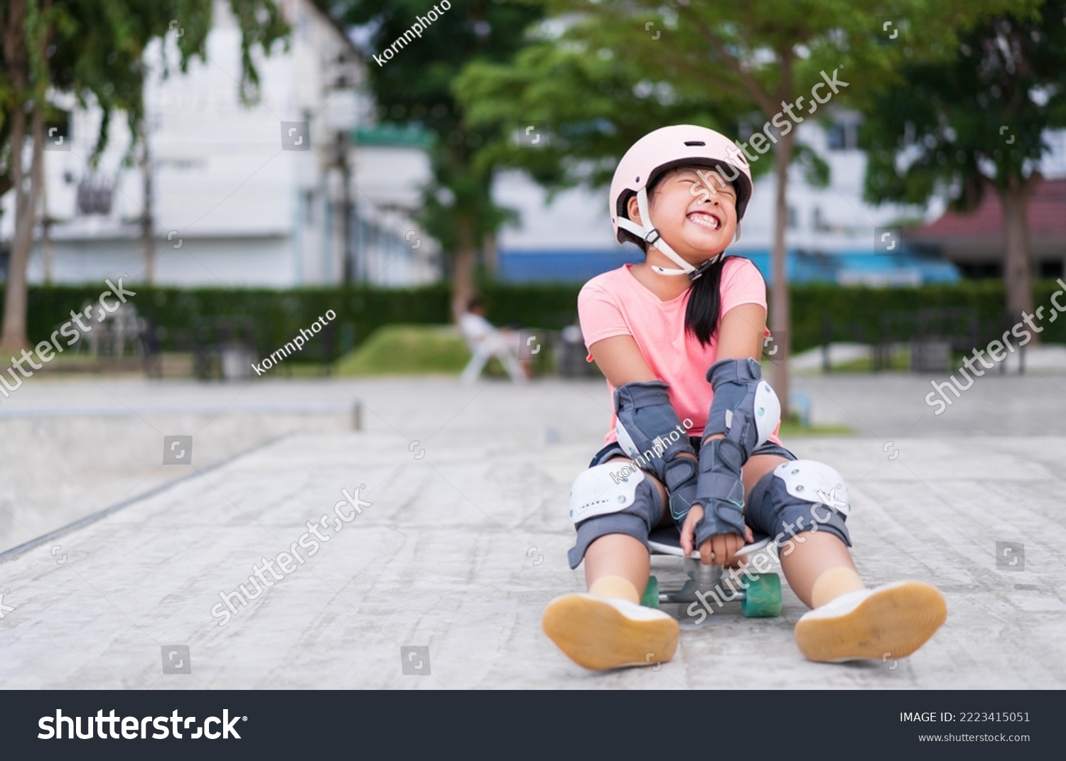 asian child skater or kid girl smile playing skateboard or sitting laugh on surf skate and enjoy fun in skate park for extreme sports exercise to wear helmet elbow wrist knee support for body safety #2223415051