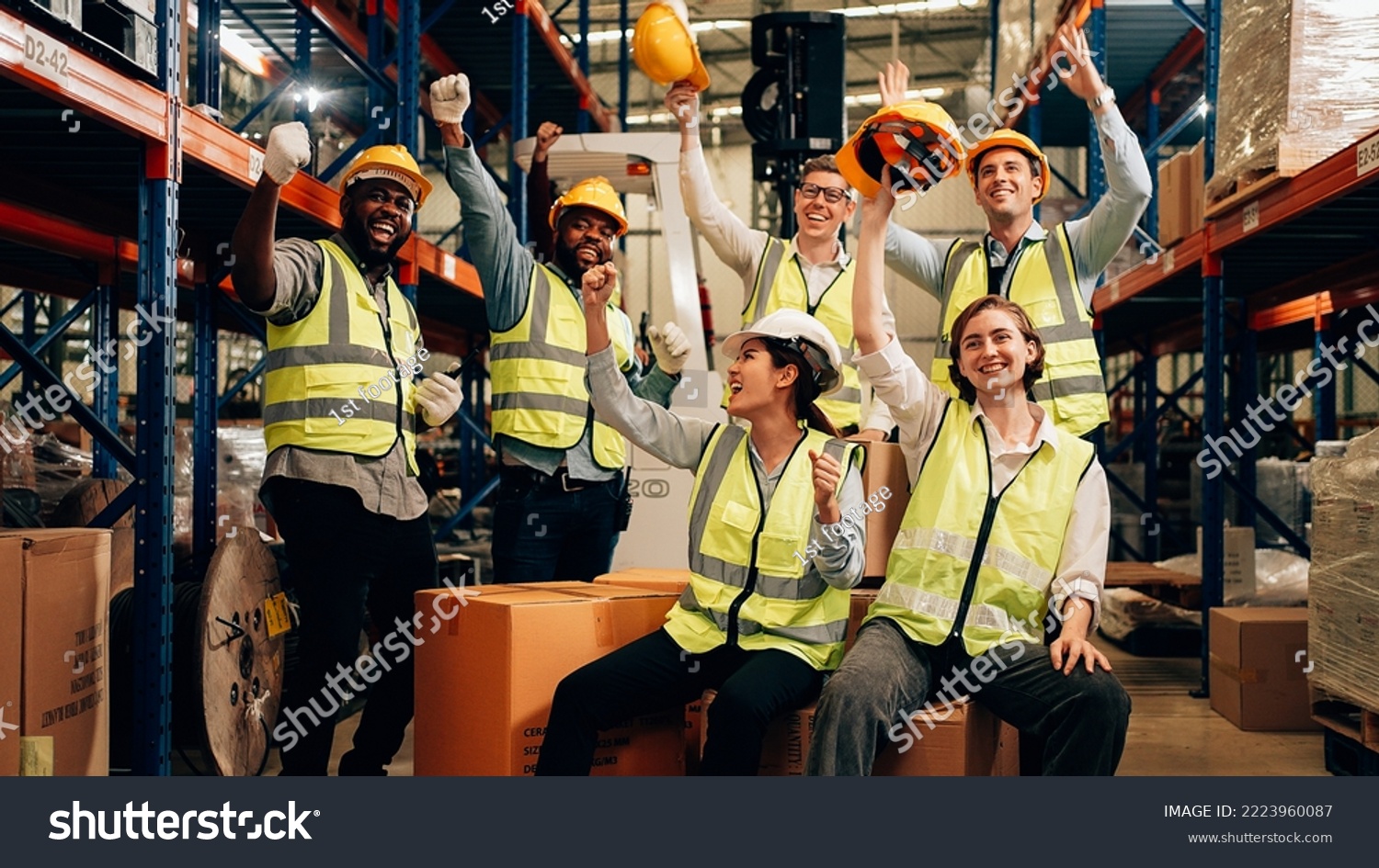Professional warehouse worker team celebrating success in warehouse factory, Cheerful workers having fun at work, Happiness at job, Concept of success, Happy team enjoying their successful job #2223960087