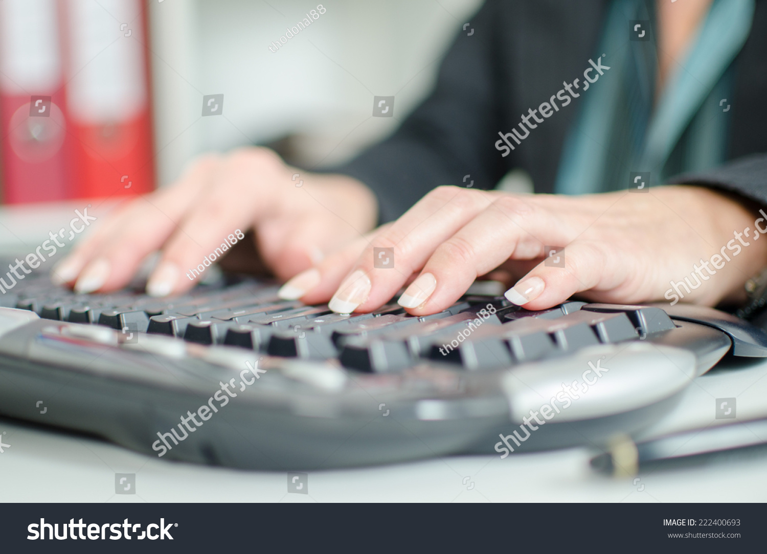 Woman's hands typing on a keyboard #222400693