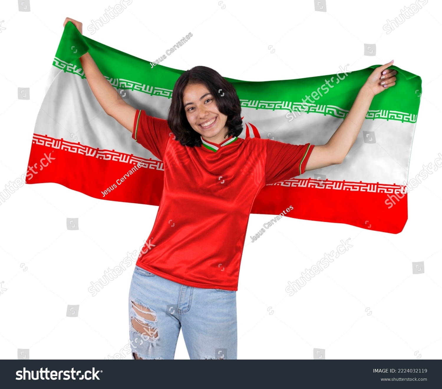 Young soccer fanatic woman with red sports jersey and flag to IR IRAN in his hands, happy for the victory of his favorite team. #2224032119