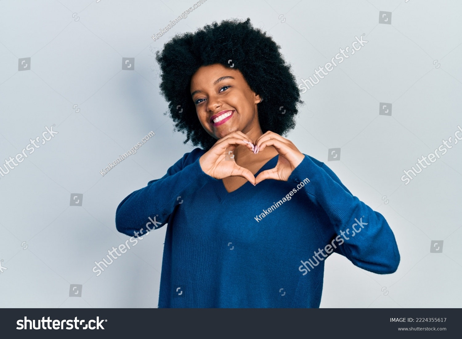 Young african american woman wearing casual clothes smiling in love doing heart symbol shape with hands. romantic concept.  #2224355617
