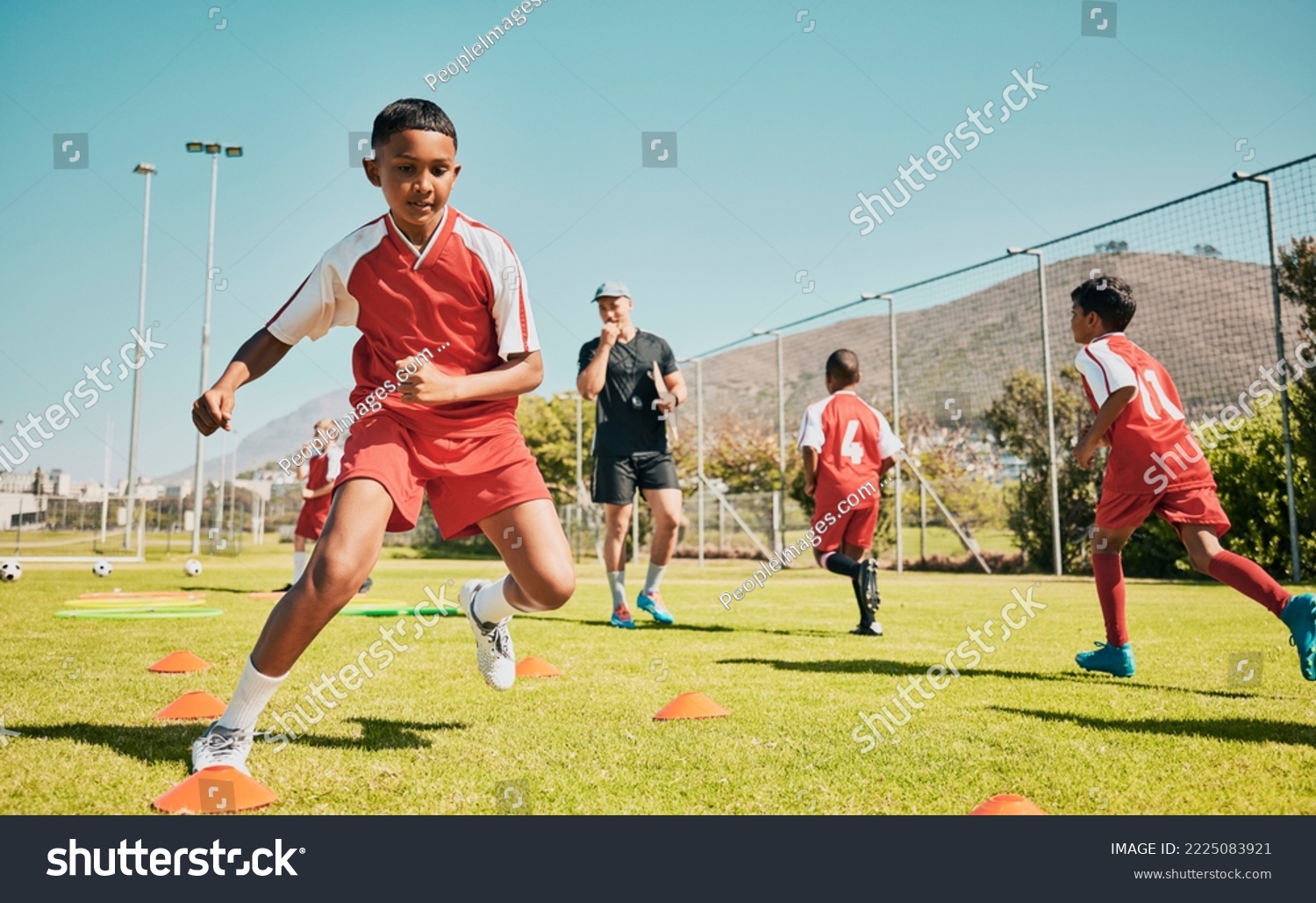 Soccer, children and training or practice for sports competition or game on soccer field for fitness, exercise and energy. Football player, cone and sport with kids coach outdoor for team practice #2225083921