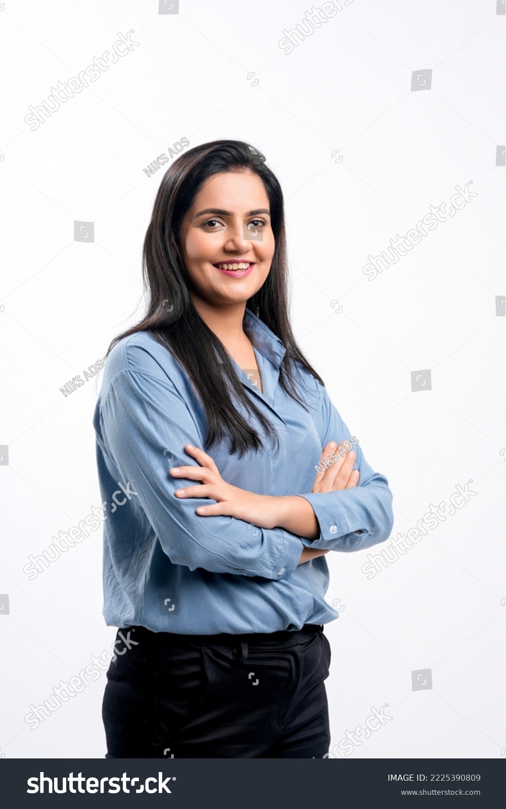 Young indian businesswoman or employee standing on white background. #2225390809
