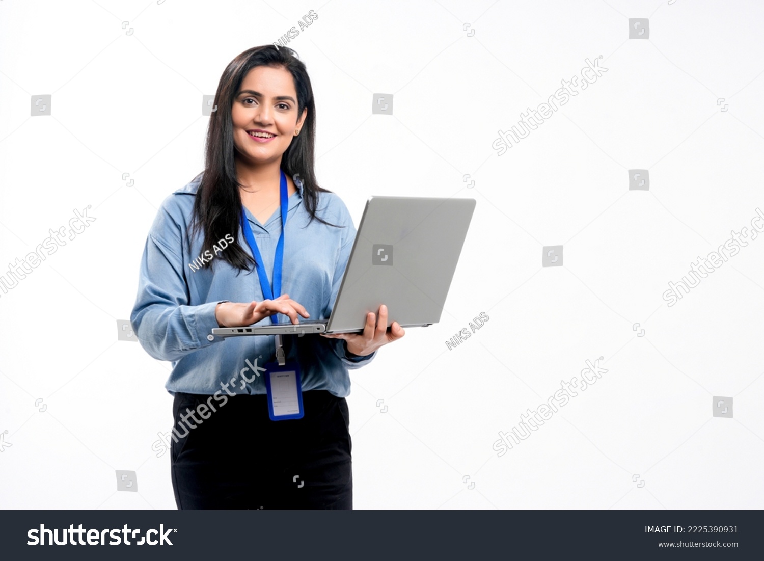 Indian businesswoman or employee using laptop on white background. #2225390931