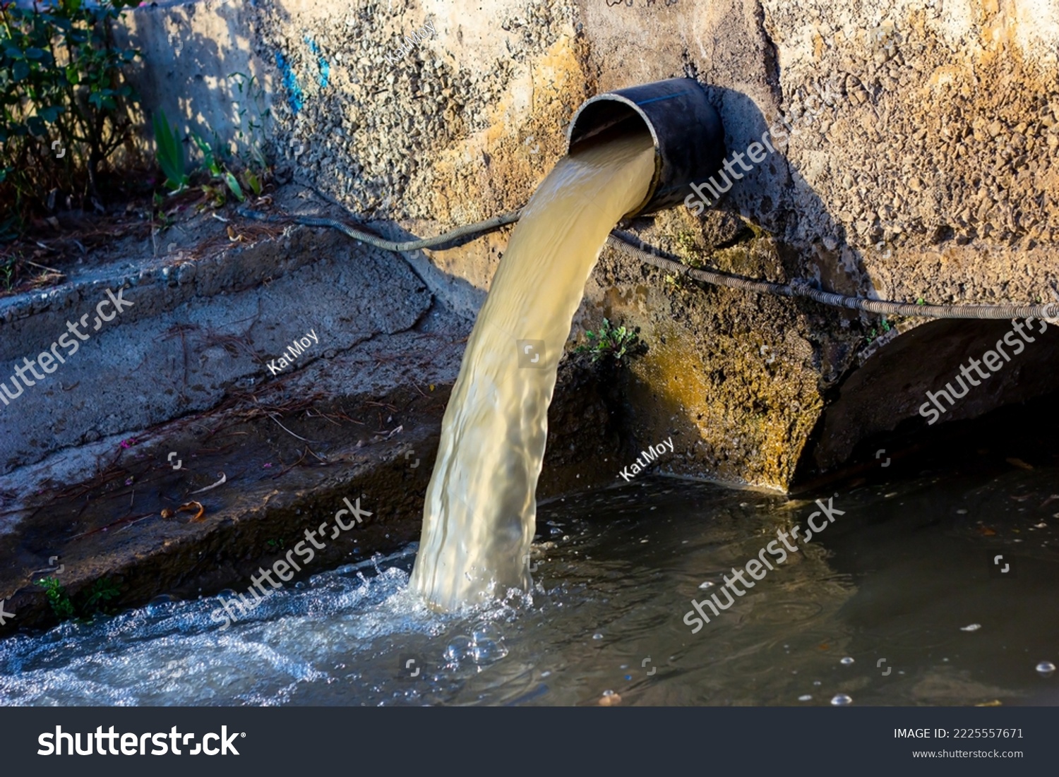 Wastewater sewage pipe dumps the dirty contaminated water into the river. Water pollution, environment contamination concept #2225557671