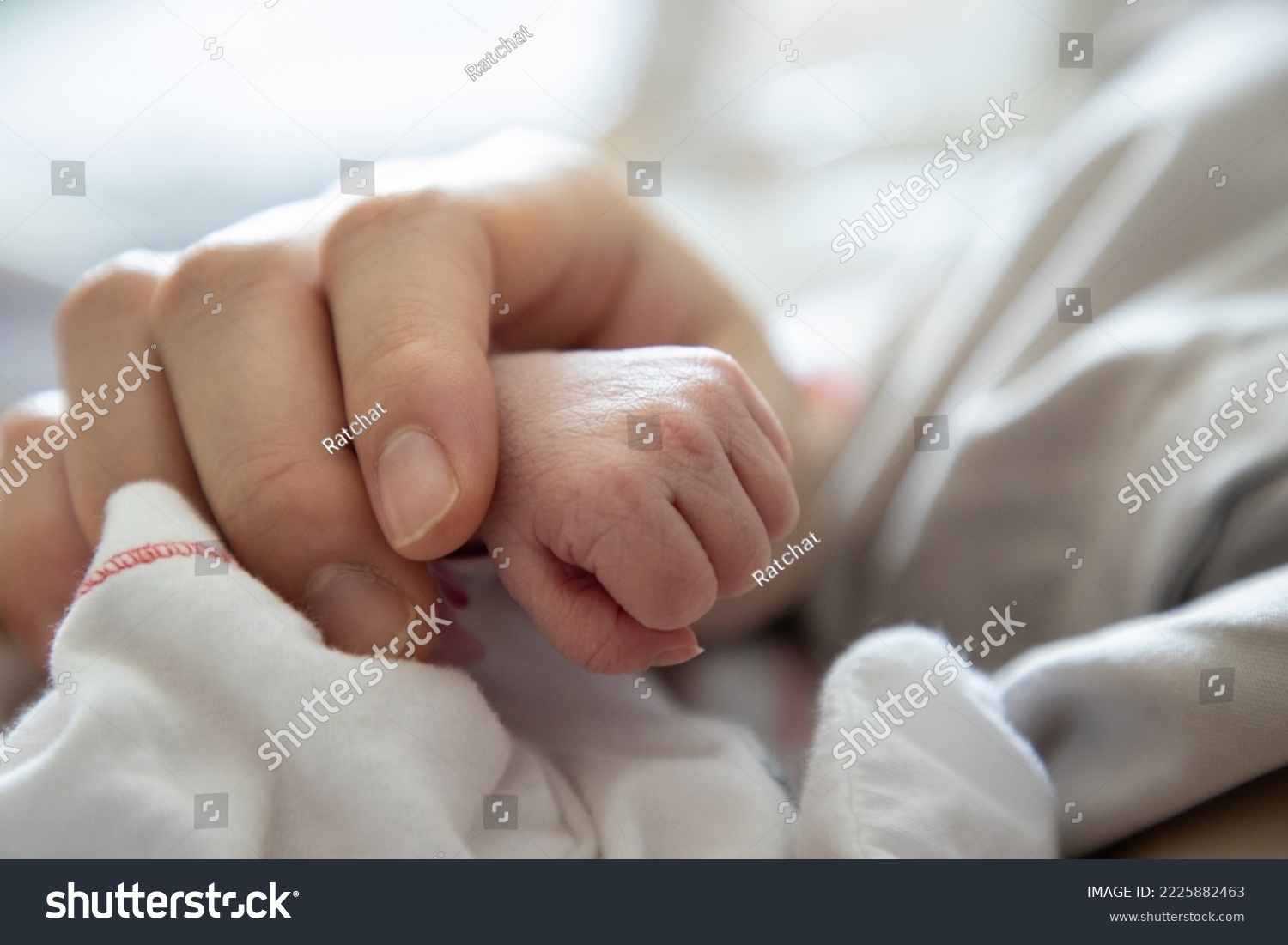 new born baby hand holded by  mum . concept : Premature or preterm baby in hospital. relationship between mother and baby. #2225882463