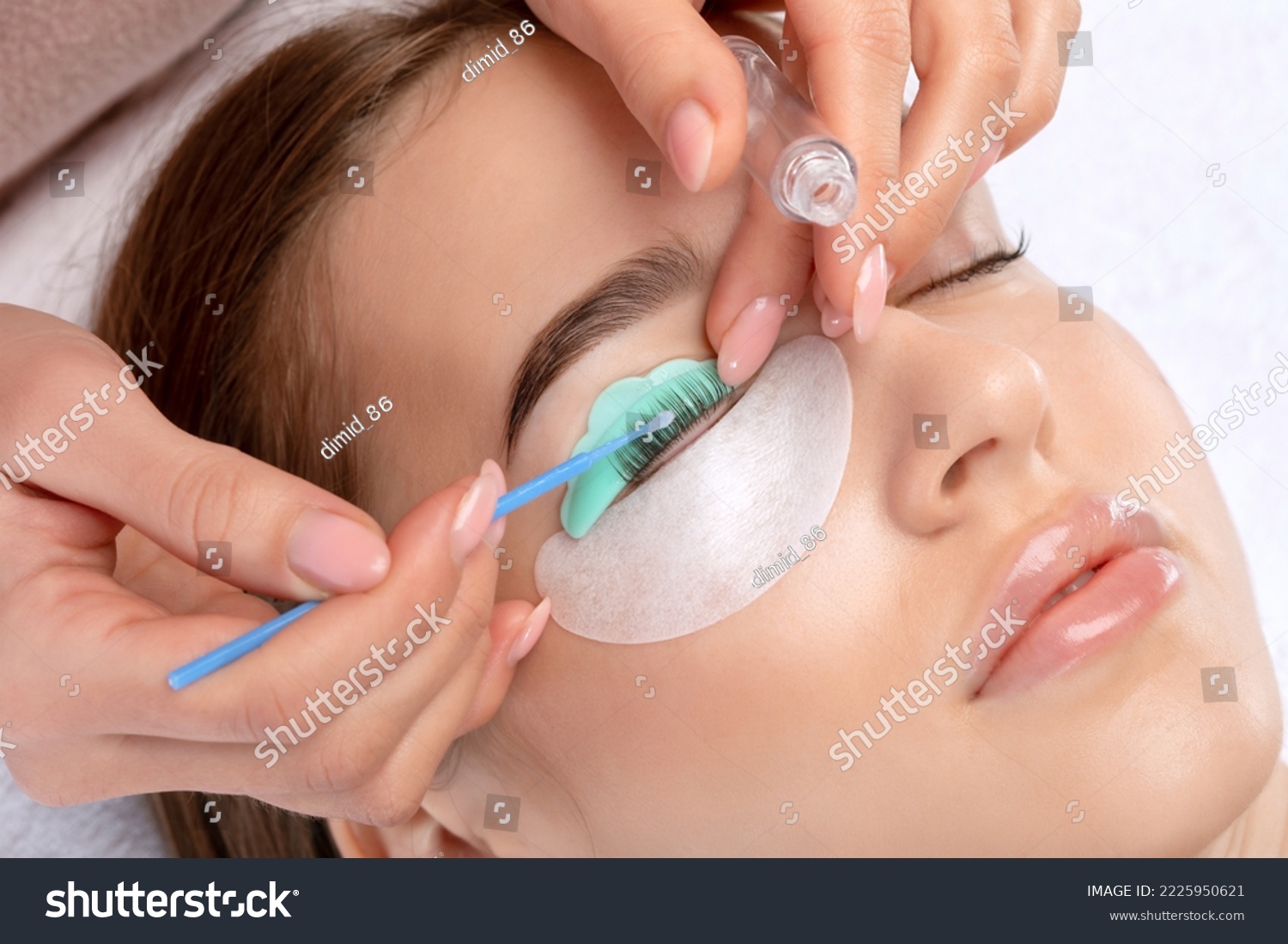 Make-up artist makes the procedure of lamination and dyeing of eyelashes to a beautiful woman in a beauty salon. Eyelash extensions. Eyelashes close-up #2225950621