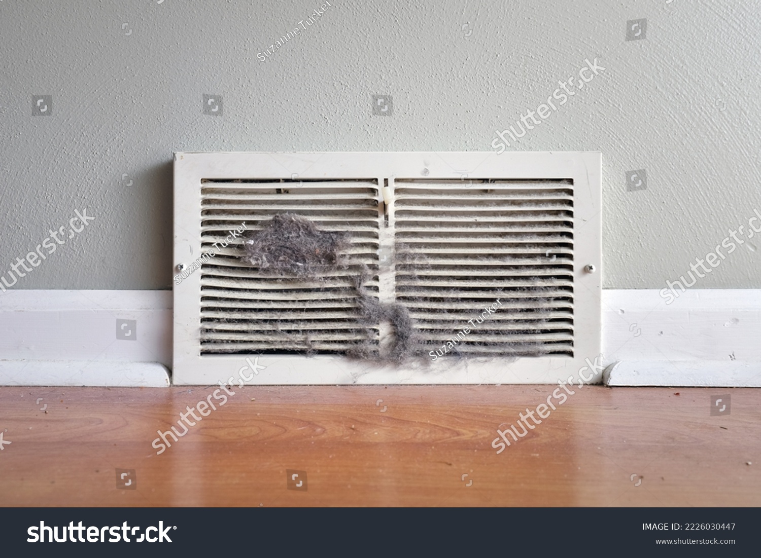 Dirty register wall vent with dust clogging the duct opening in a home  #2226030447