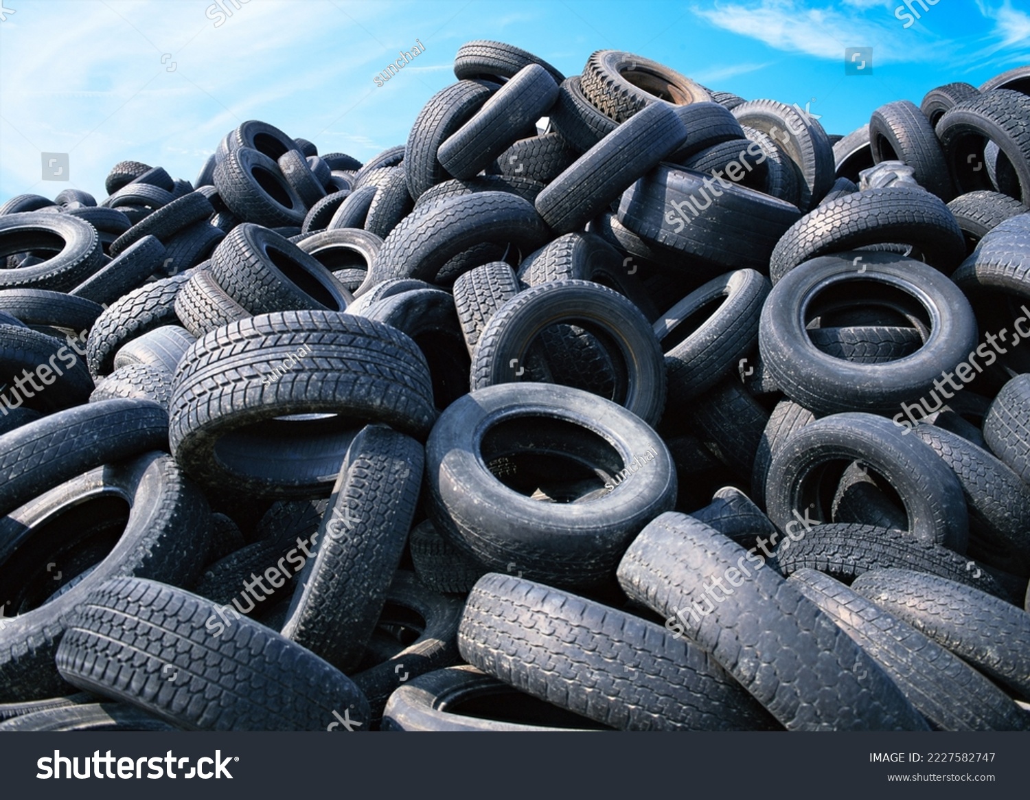 Landfill with old tires and tyres for recycling, Reuse of the waste rubber tyres, Disposal of waste tires, Worn out wheels for recycling, Tyre dump burning plant, Regenerated tire rubber. #2227582747