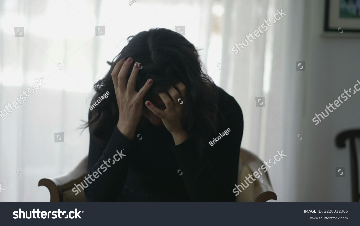 Woman covering face in shame suffering from emotional pain #2228312365