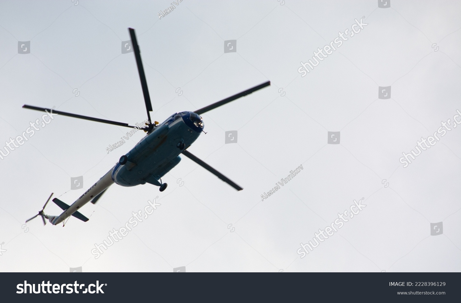 Passenger tourist helicopter Mi-8 doing sightseeing flight. Helicopter in the sky bottom view. #2228396129