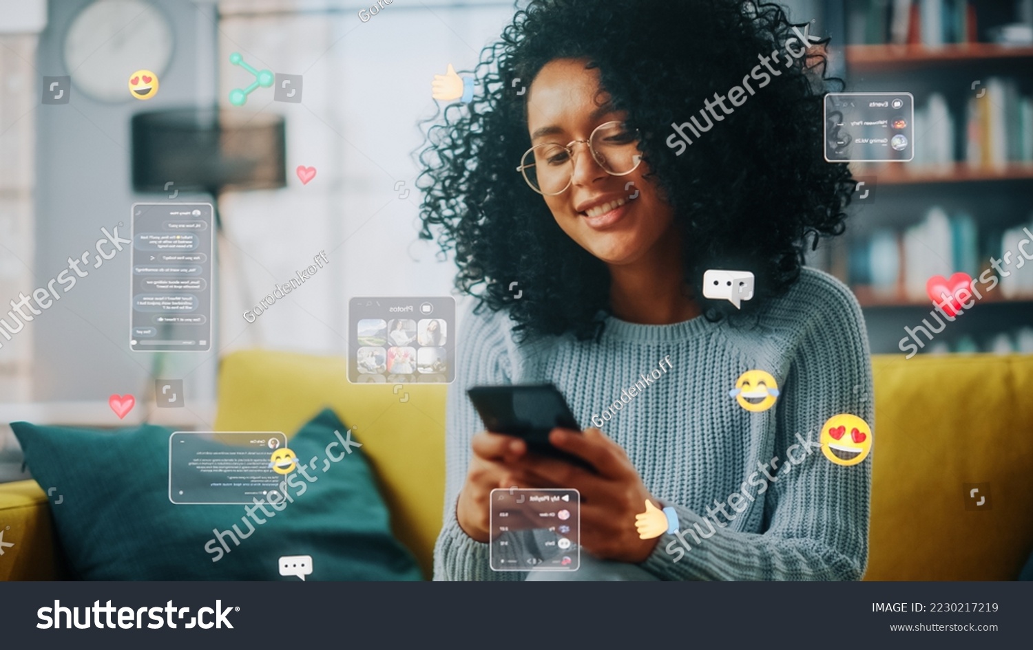 Social Media Visualization Concept: Happy Black Woman Uses Smartphone at Home. 3D Representation of Social Media Posts, Smiley Faces, e-Commerce Online Shopping Digital Icons Flying Around the Device #2230217219