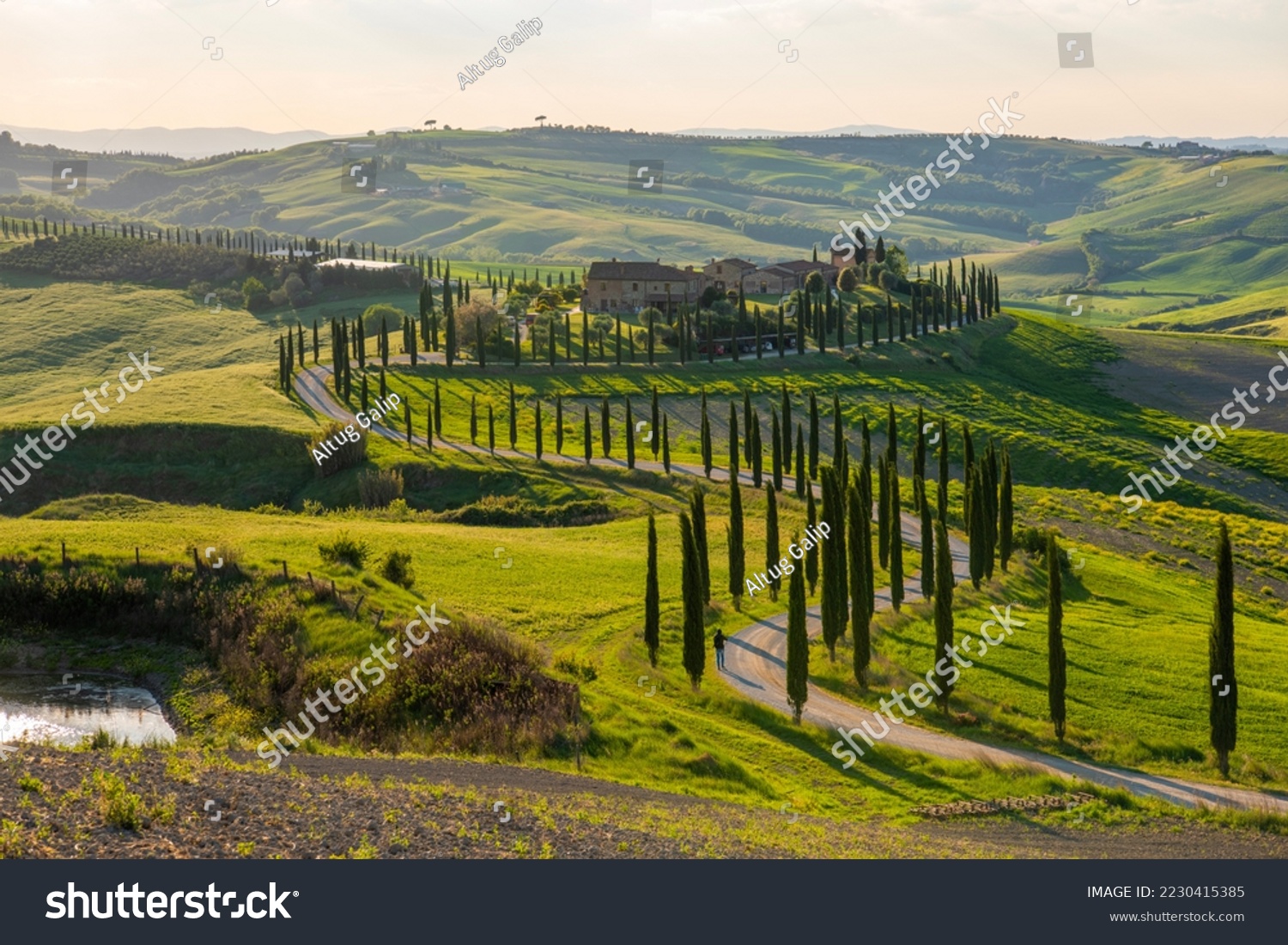 Panoramic view of a farmhouse near Asciano with Val d'Orcia hills in the background. #2230415385