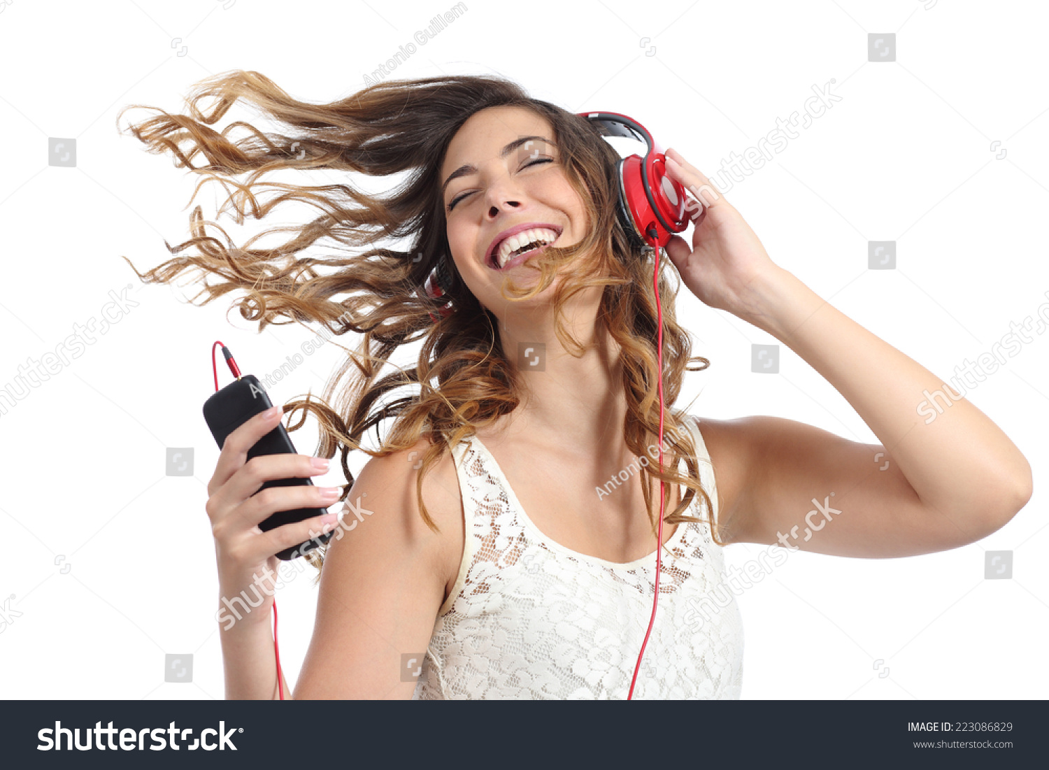 Happy girl dancing and listening to the music isolated on a white background #223086829