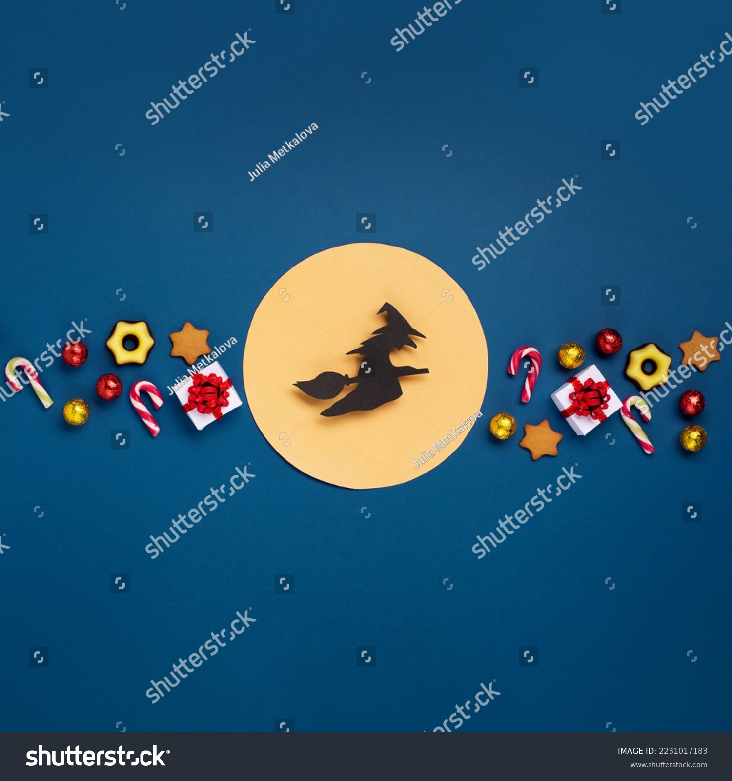 Italian Epiphany day or Dia da Reyes Magos tradition. Witch Befana flying on broomstick, moon, stars and christmas sweets on dark blue background. Top view, copy space. Winter holiday card concept. #2231017183