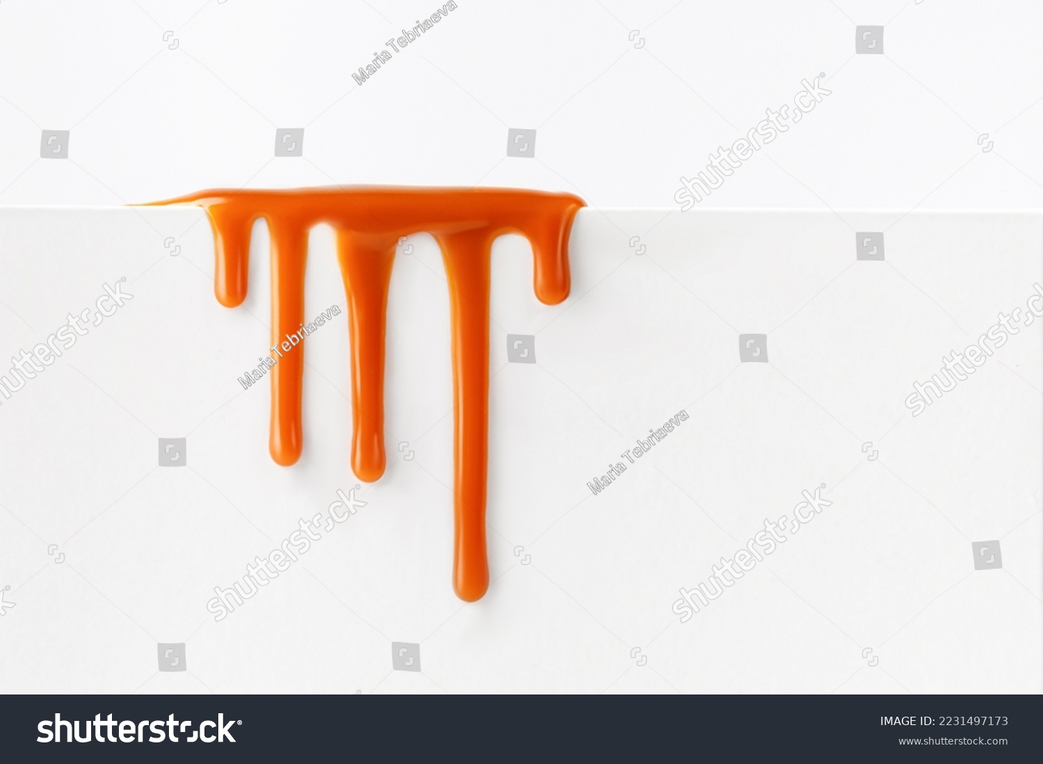 Dripping caramel drops of sweet caramel sauce isolated on white background. Melted caramel sauce drip, drops of sweet liquid toffee. #2231497173