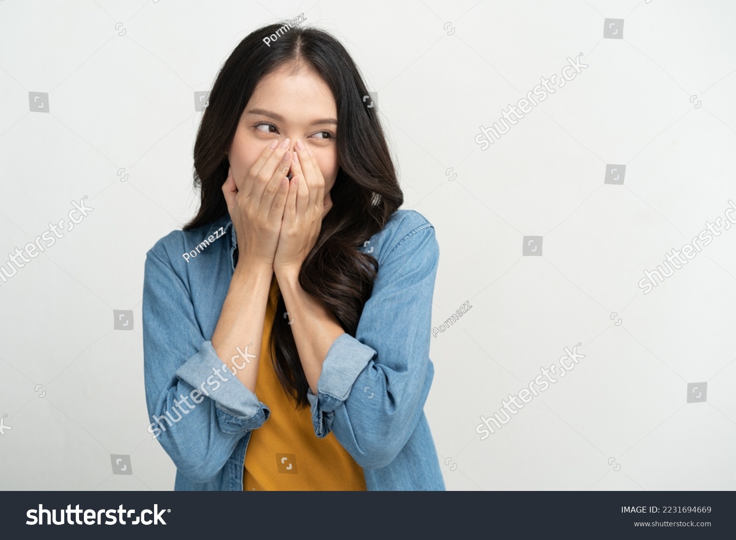 Young woman feeling embarrassed covering her face with her hands #2231694669