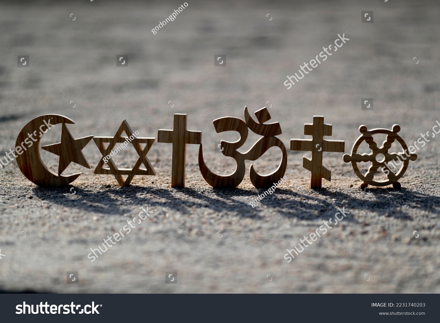 Religious symbols on sand. Christianity, Islam, Judaism, Orthodoxy Buddhism and Hinduism. Interreligious or interfaith concept.
 #2231740203