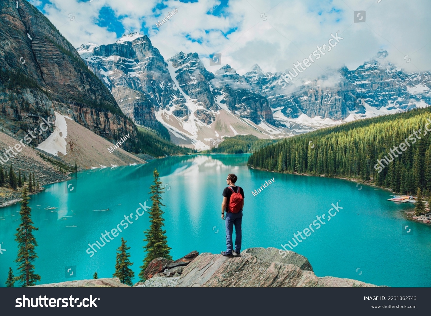 Canada travel man hiker at Moraine Lake Banff National Park, Alberta. Canadian rockies landscape people hiking with backpack lifestyle #2231862743