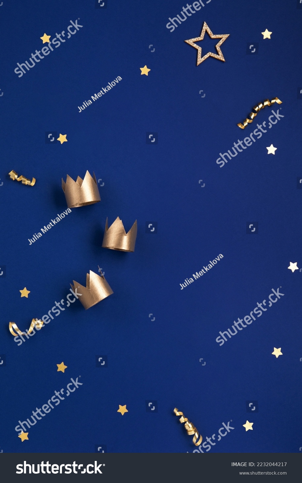 Traditional Three King's Day of January 6. Three gold crowns on blue background. Concept for Dia de Reyes Magos day, three Wise Men. Happy Epiphany day. Top view, copy space, flat lay. #2232044217