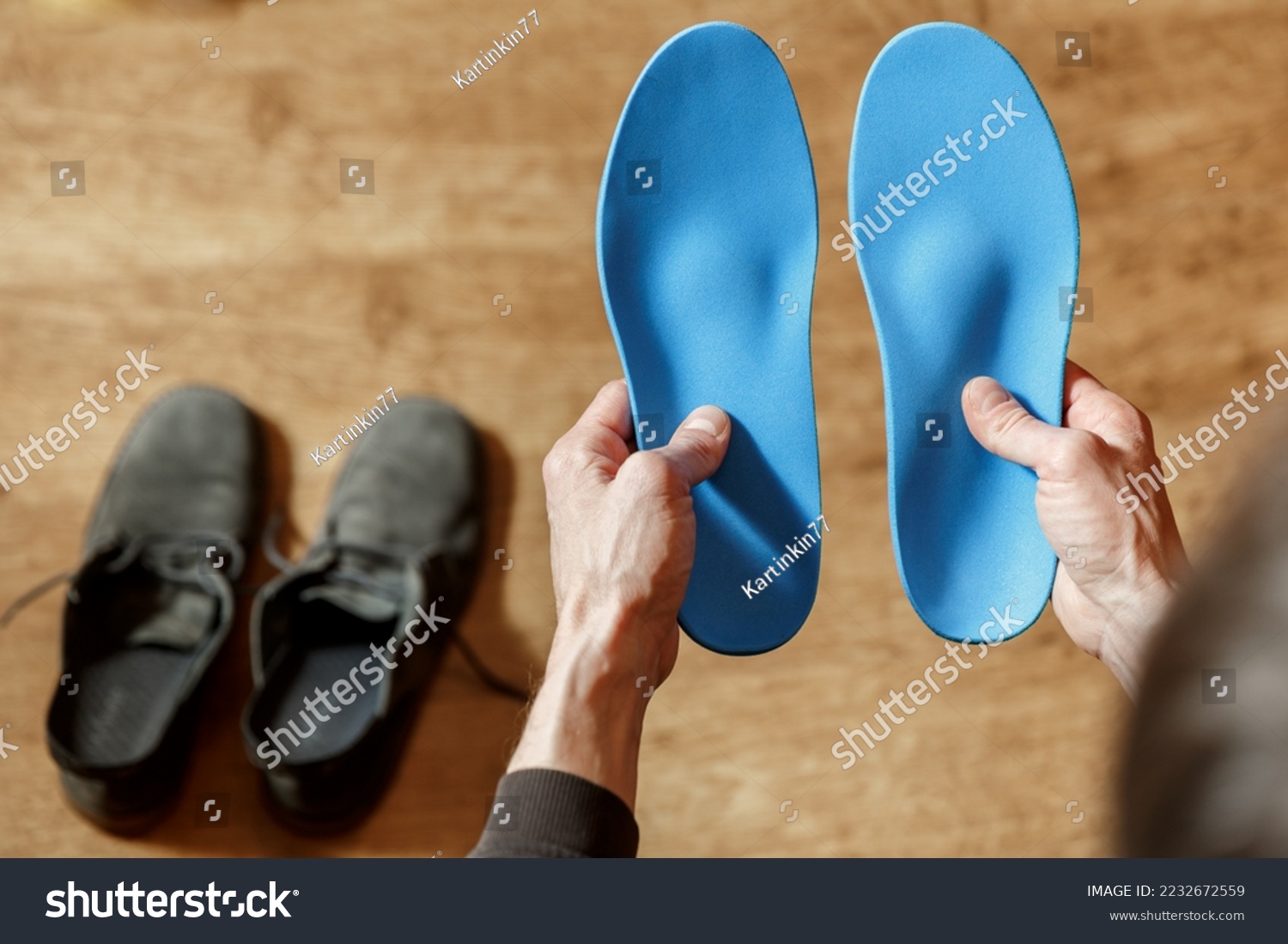 Сustom orthopedic insoles in a male hands. Man holding new cusmom insoles. Feet recreation medicine concept #2232672559