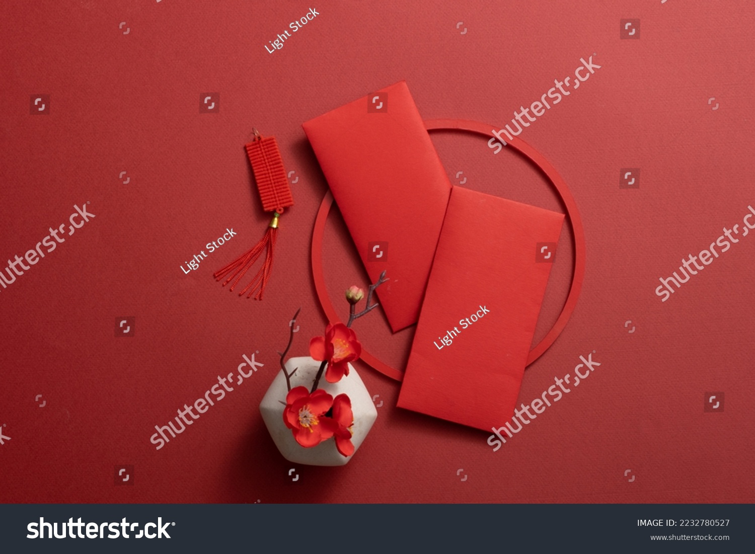 Top view of lucky envelopes and decorative items for Chinese lunar new year on red background. Space for text #2232780527