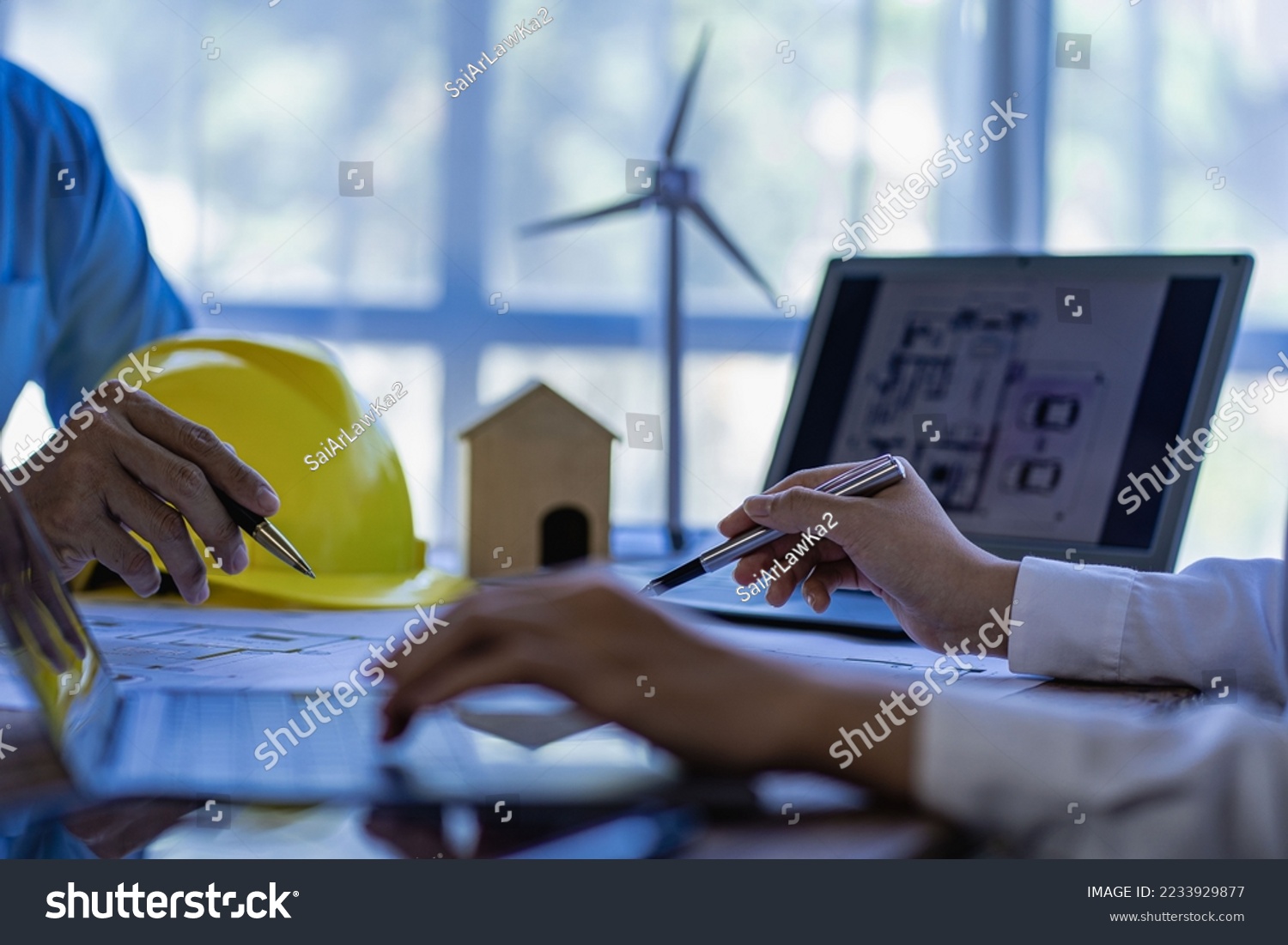 Professional design engineers discuss calculations to use pure natural energy and installing solar panels and wind turbines on the roof of houses to generate electricity, energy saving and global warm #2233929877