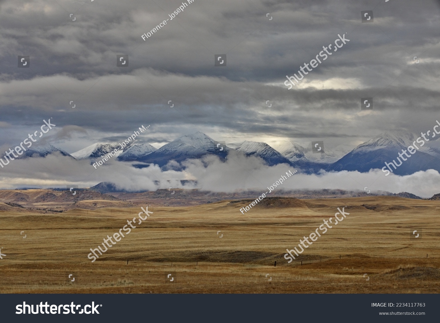 Beautiful scenery of distant mountains and wide prairie abound on Rt 191 near Big Timber, Montana, gateway to Absaroka-Beartooth Wilderness and adventure.   #2234117763