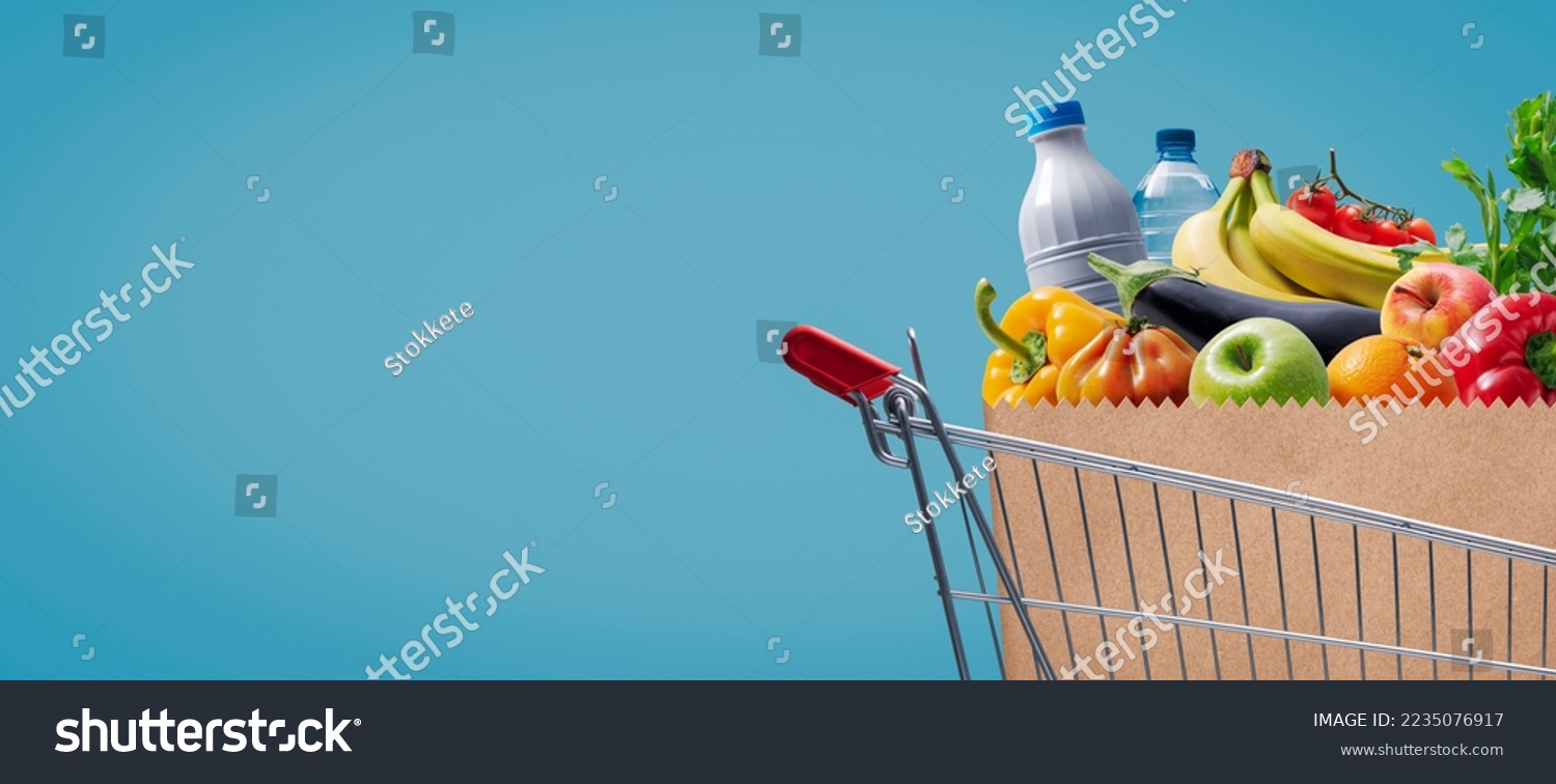 Supermarket shopping cart full of groceries, sale and retail concept, copy space #2235076917