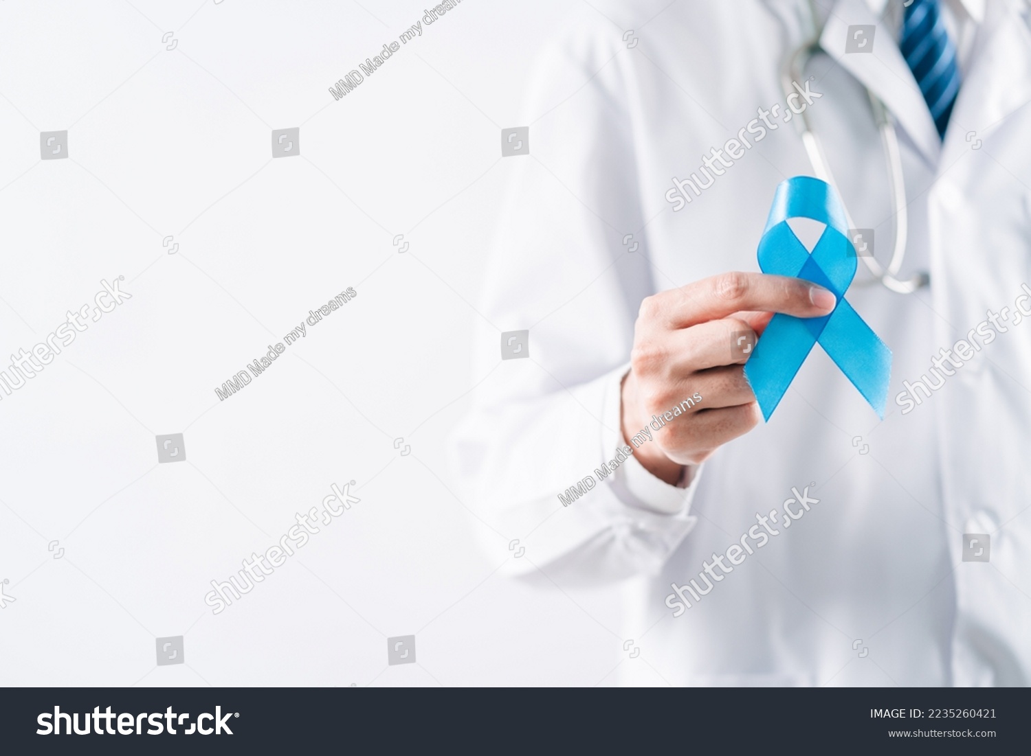 doctor in a white coat hands holding Blue ribbon for supporting people living and illness, Colon cancer, Colorectal cancer, Child Abuse awareness, world diabetes day, International Men's Day #2235260421