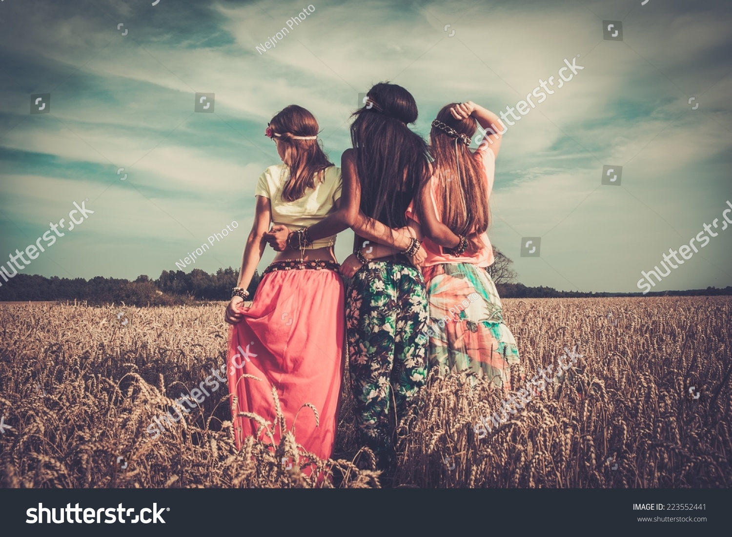 Multi-ethnic hippie girls  in a wheat field  #223552441