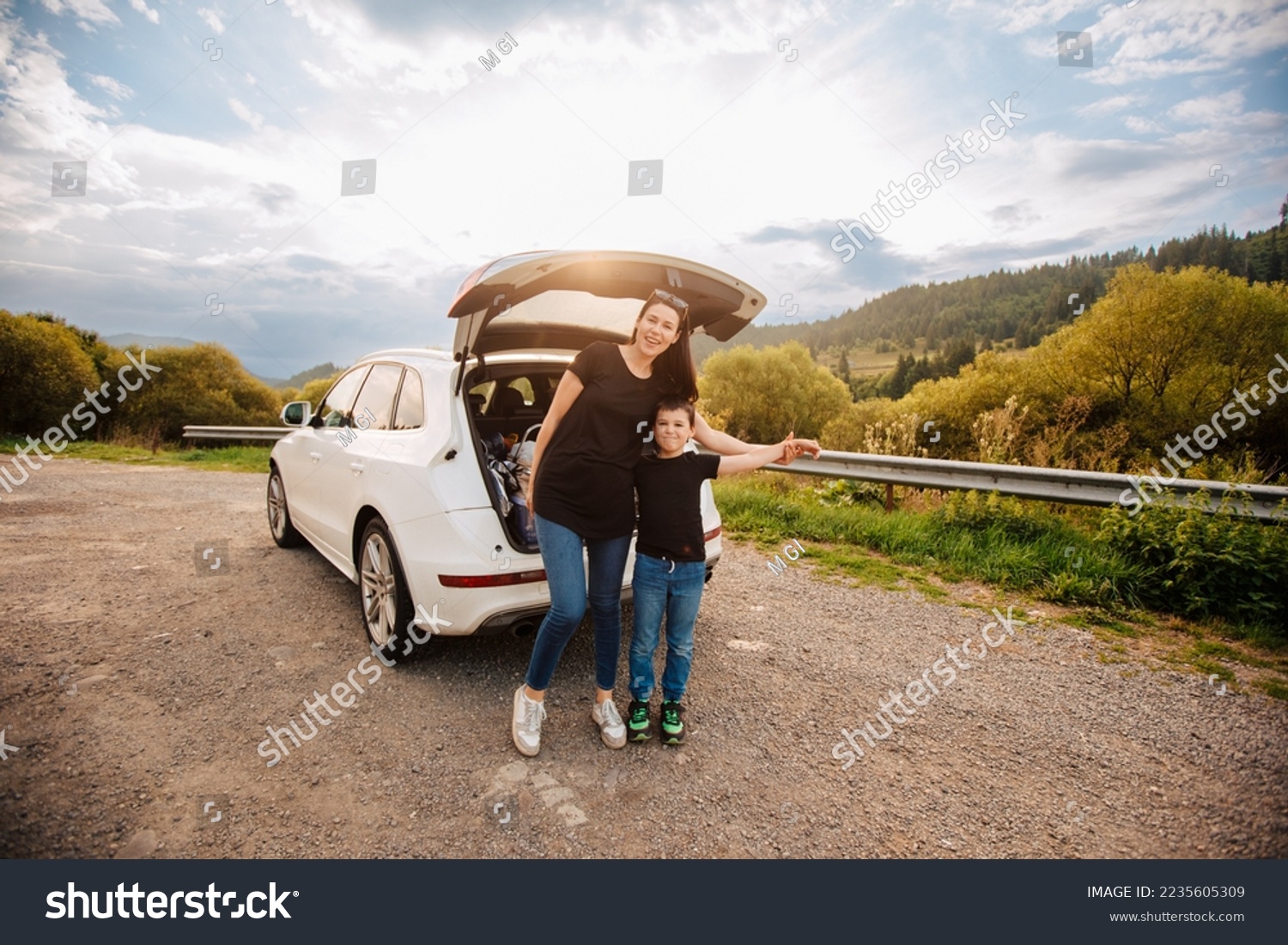 Road trip mith son. Woman with a child in summer clothes in the mountains. Couple of mother with her son on vacation. Single mom on vacation with his boy. Road trip with child	 #2235605309