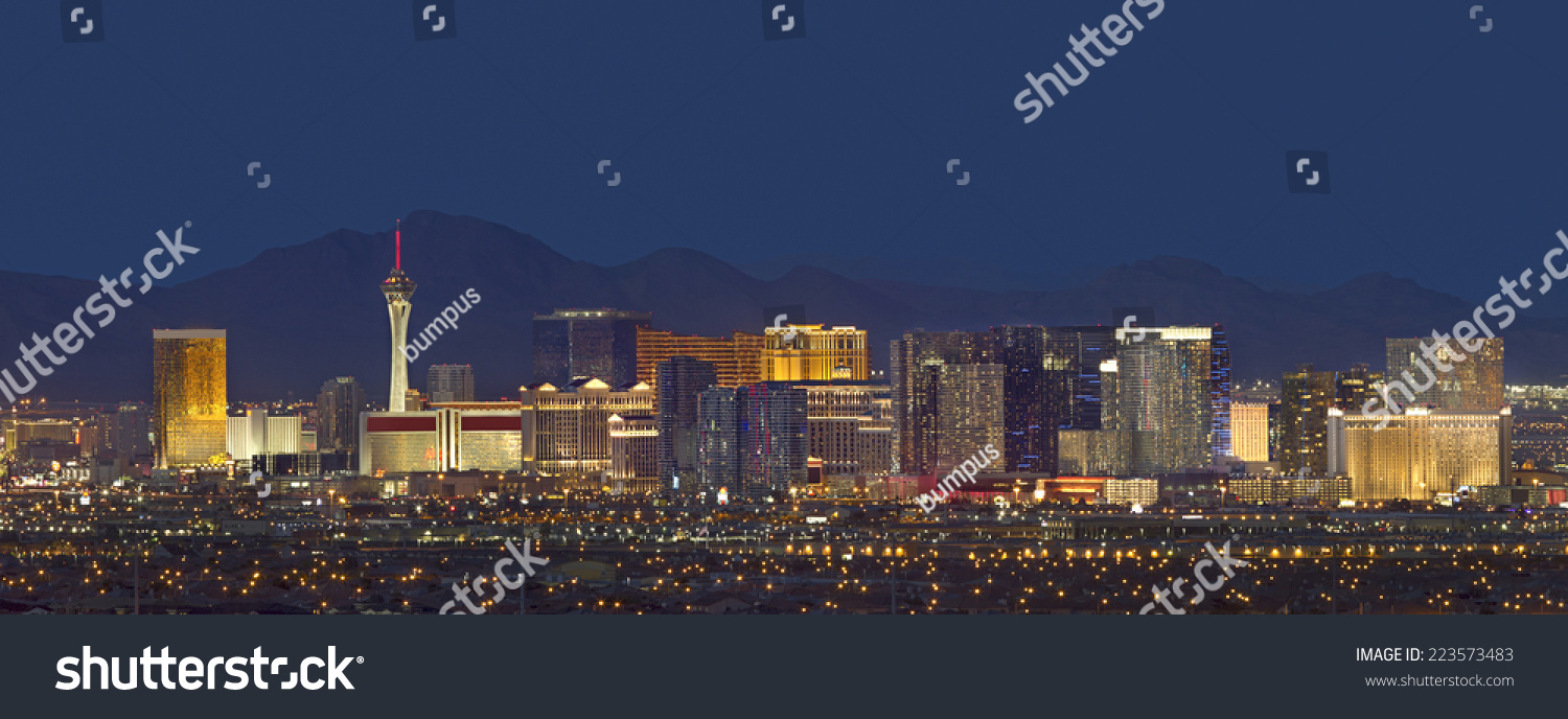 Horizontal photo of Las Vegas with mountain backdrop at night. #223573483