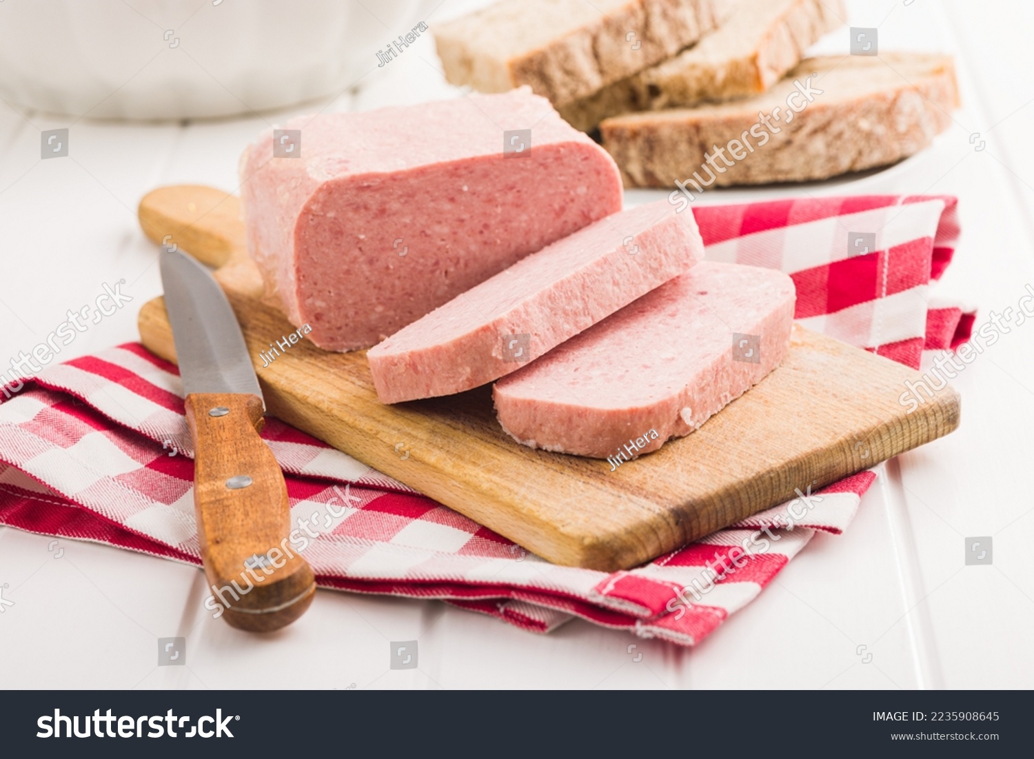Luncheon meat on the cutting board. #2235908645