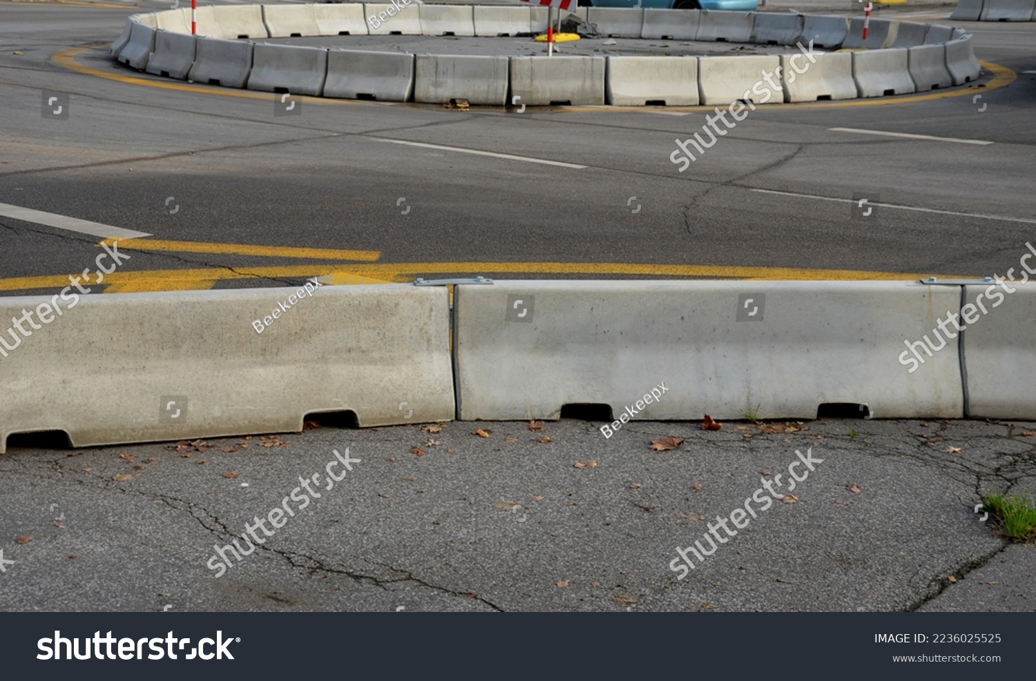 horizontal road marking lanes. highway concrete barriers on the road. vehicle collision lane separator. yellow color with black stripes. the road roundabout  concrete barriers #2236025525