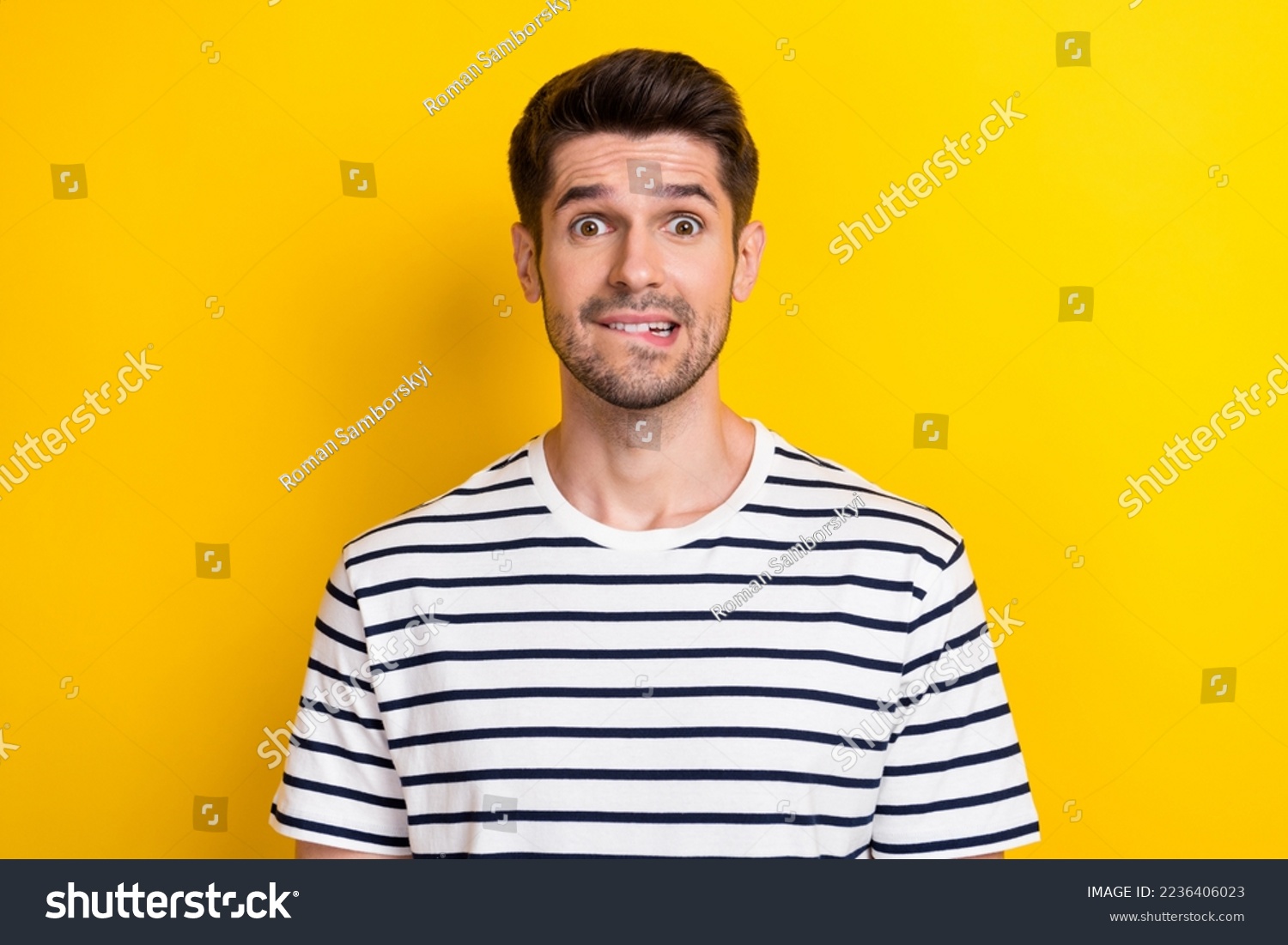 Photo of young funny grimace guy student oops mistake bite lips nervous forgot his house keys lost isolated on bright yellow color background #2236406023