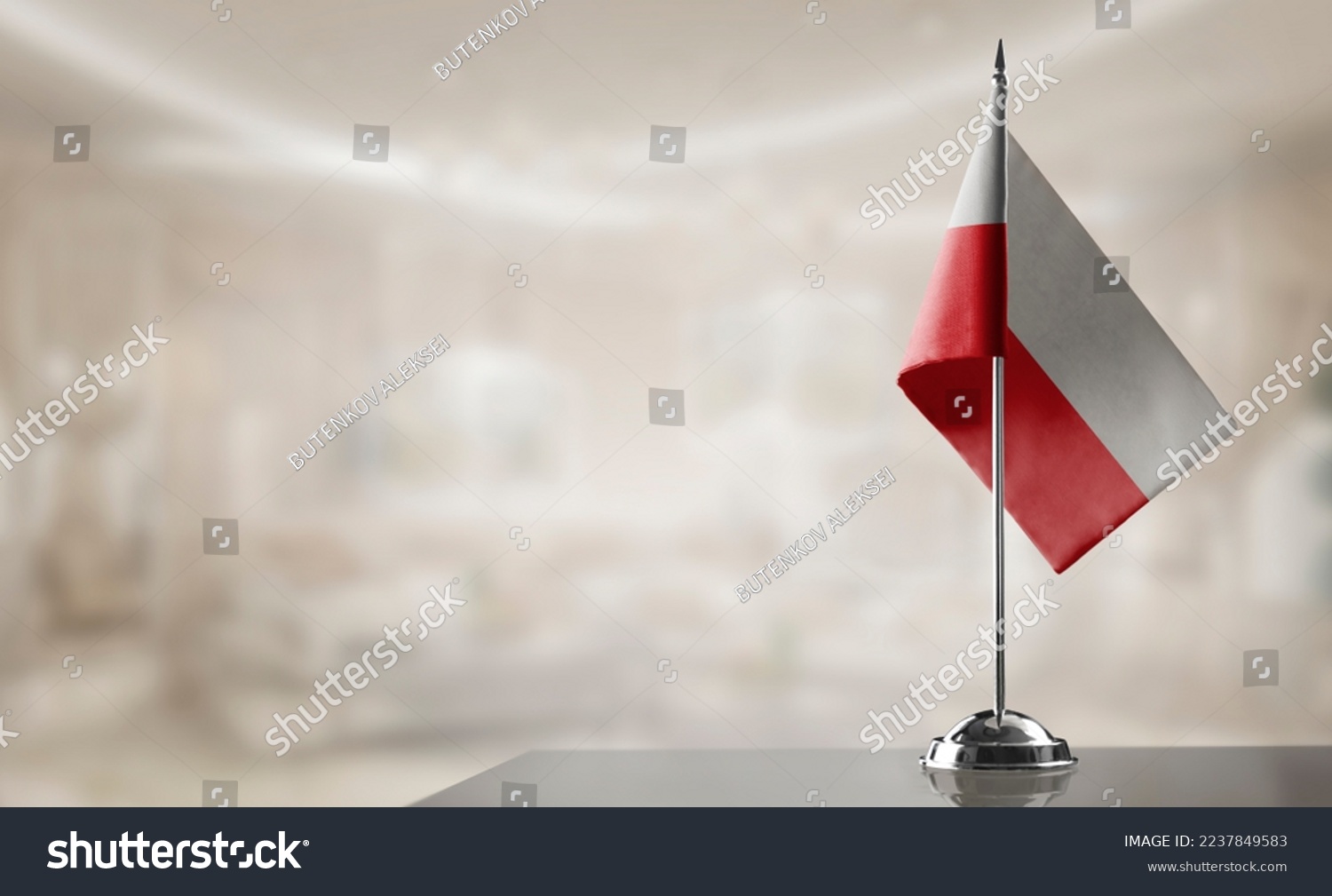 A small Poland flag on an abstract blurry background #2237849583