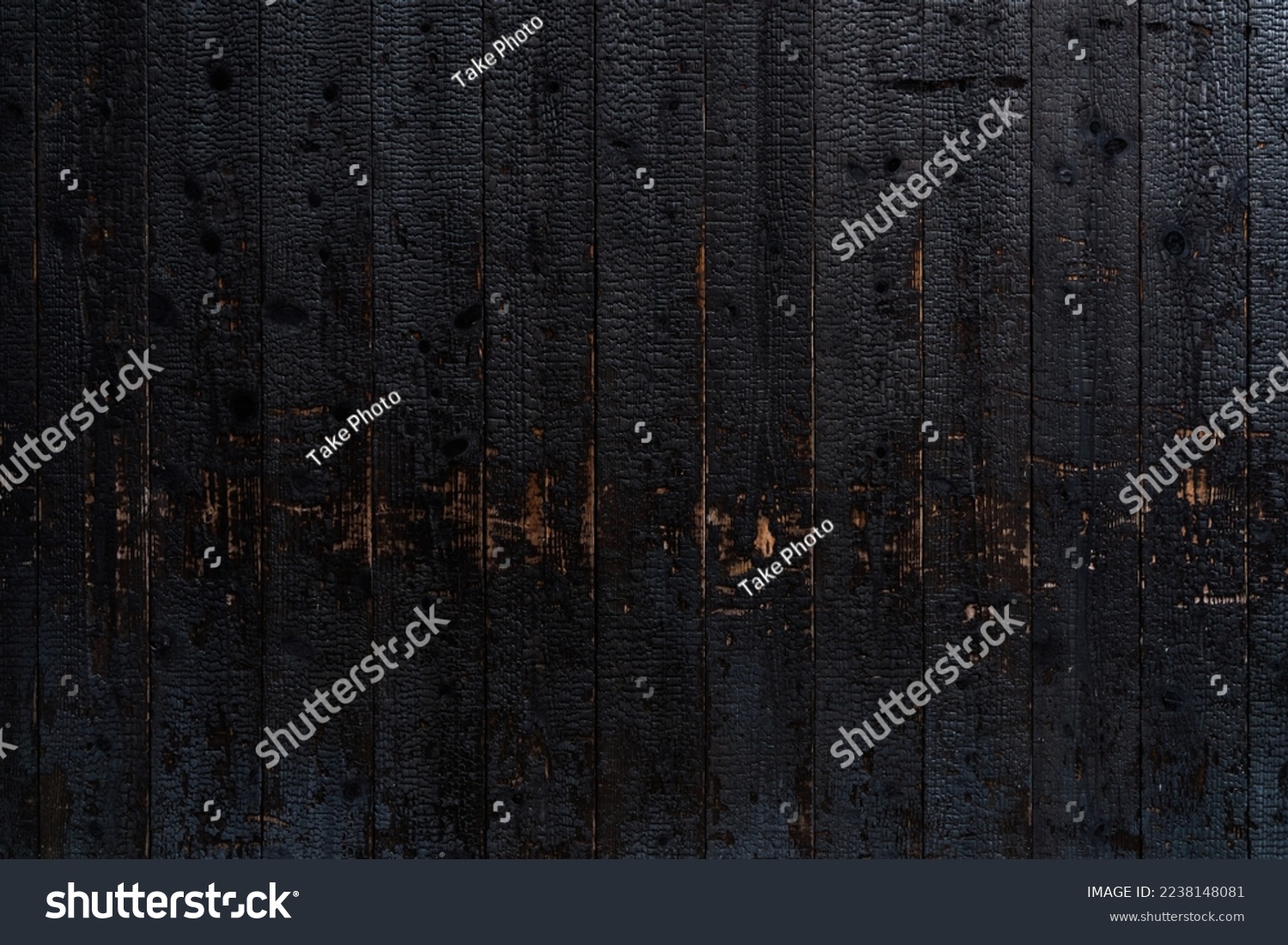 Burnt wooden plank surface after a fire. Details with patterned wood surface texture was charred. Footprint of Fire on Its Surface .Background Texture for use #2238148081