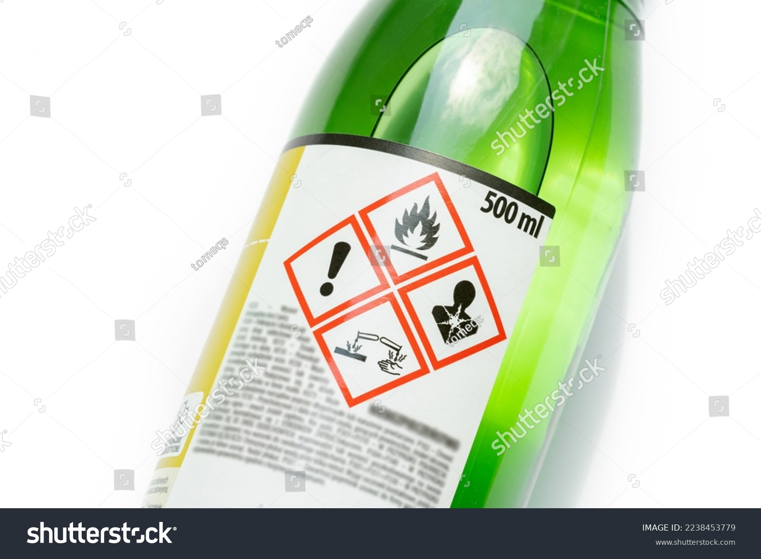 A green bottle of highly corrosive flammable chlorinated rubber nitro solvent with printed on warning symbols label, sticker. Dangerous chemical substances abstract concept, closeup, detail, nobody #2238453779