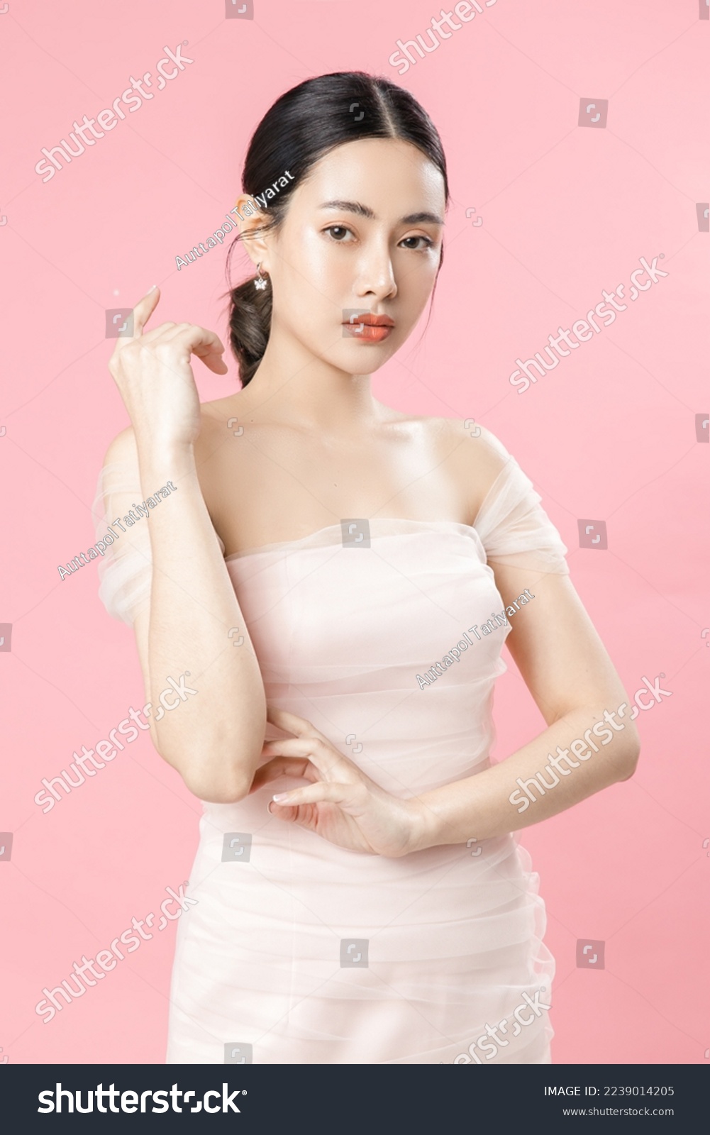 Asian woman with a beautiful face and Perfect clean fresh skin. Cute female model with natural makeup and sparkling eyes on pink isolated background. Facial treatment, Cosmetology, beauty Concept. #2239014205