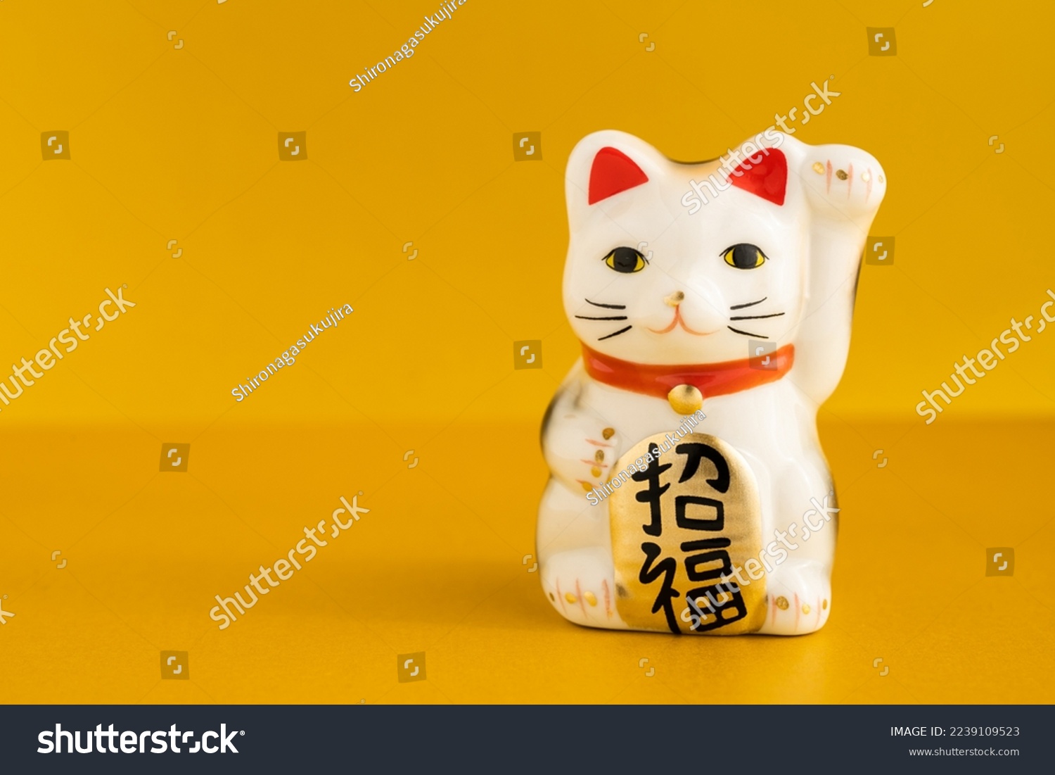 
A lucky cat figurine. In Japan, it is called manekineko. It is written as good luck in Japanese. #2239109523